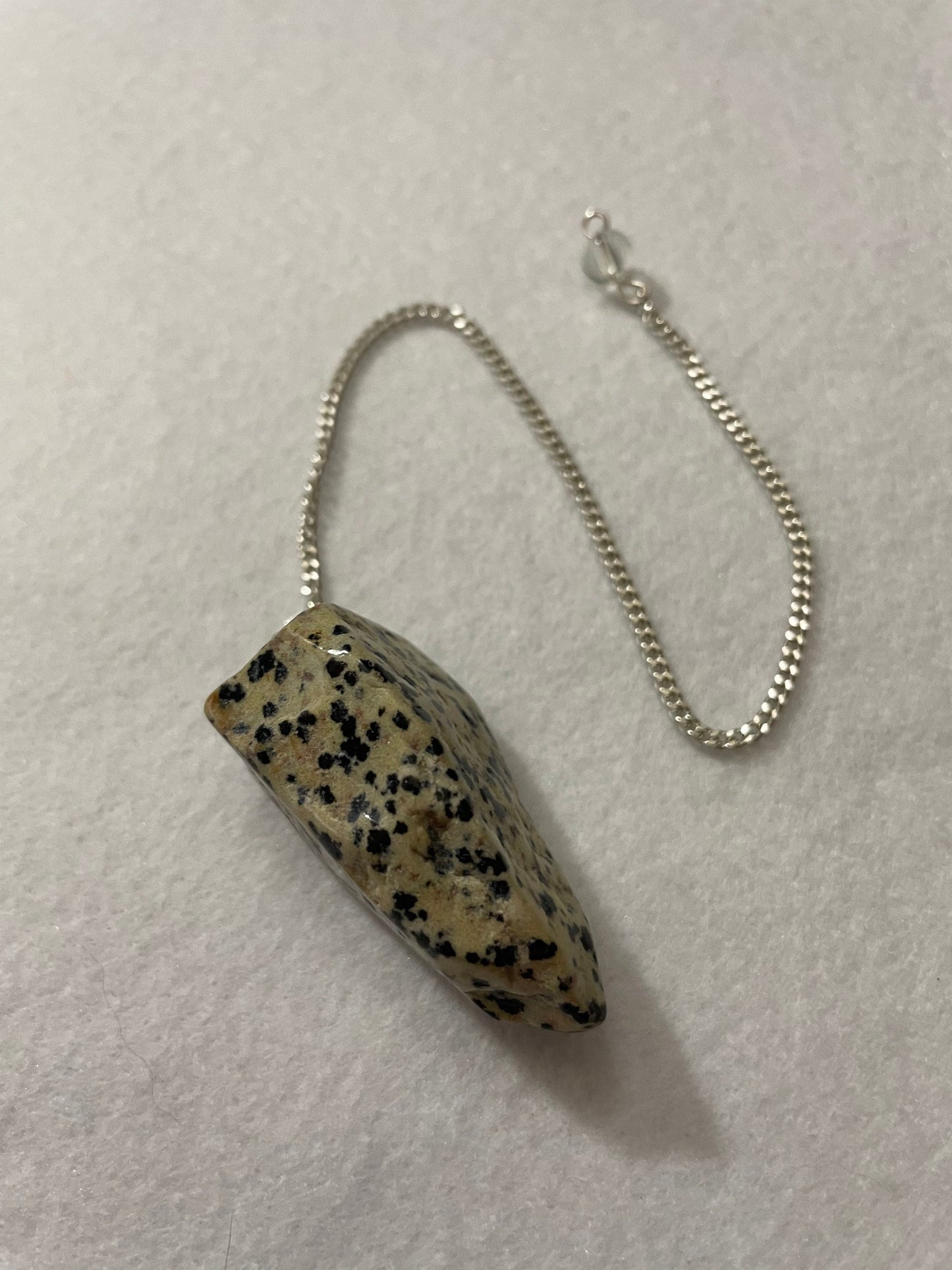 This Dalmatian Jasper Pendulum is 1.75” and with the chain is 9.5”