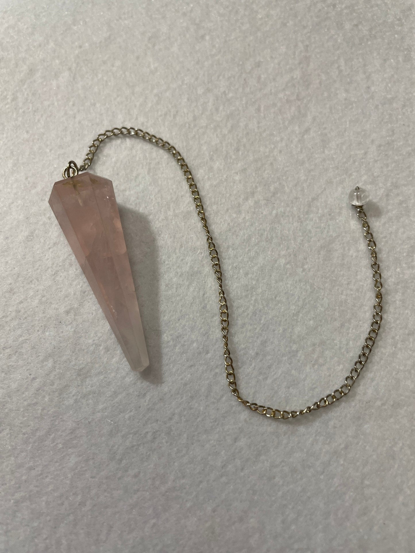 This beautiful Rose Quartz Pendulum is 1.75” and with chain is 8.75”