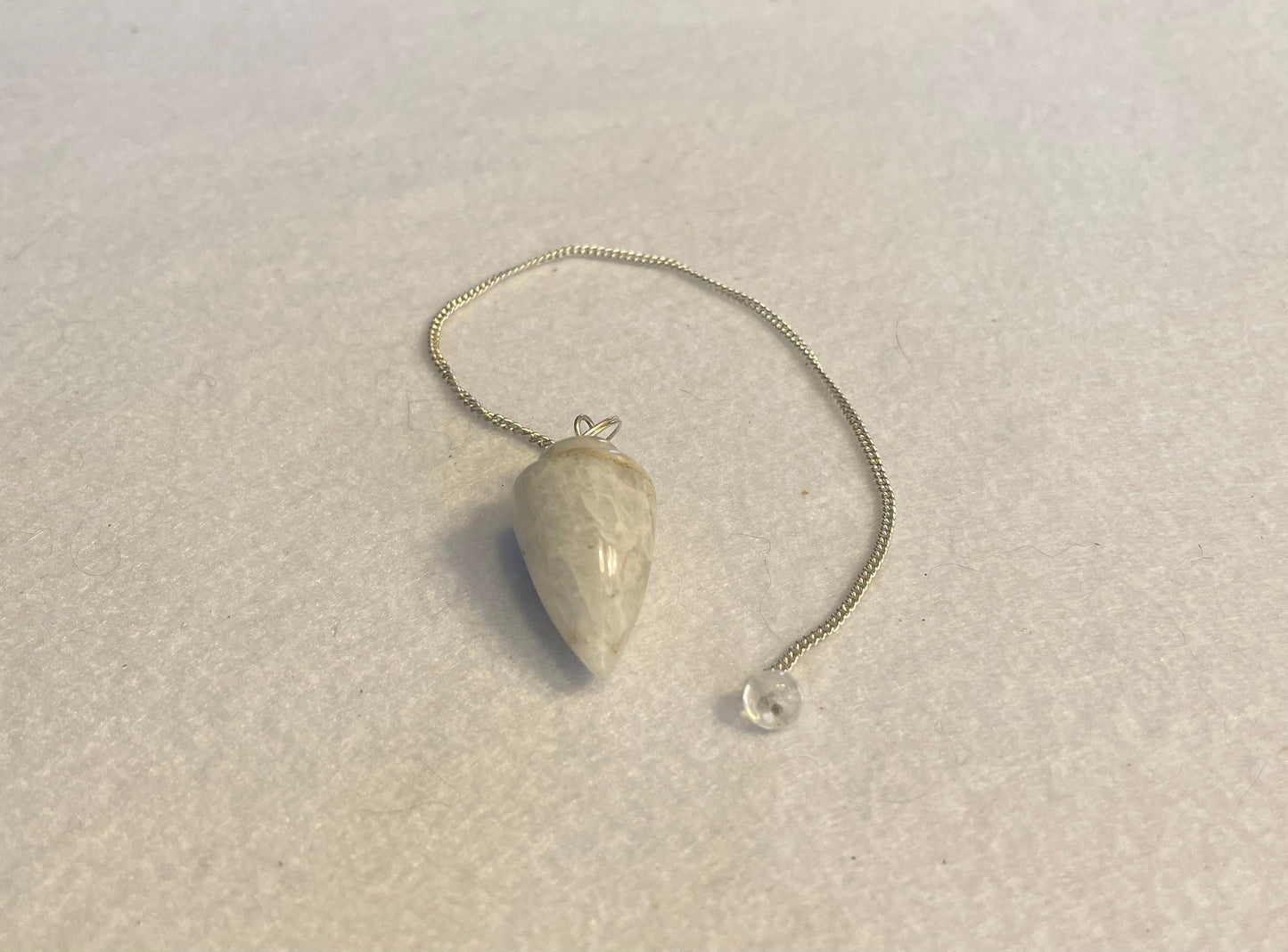 beautiful white Quartz pendulum is approximately 1 1/8” and with chain is 8.5” total length