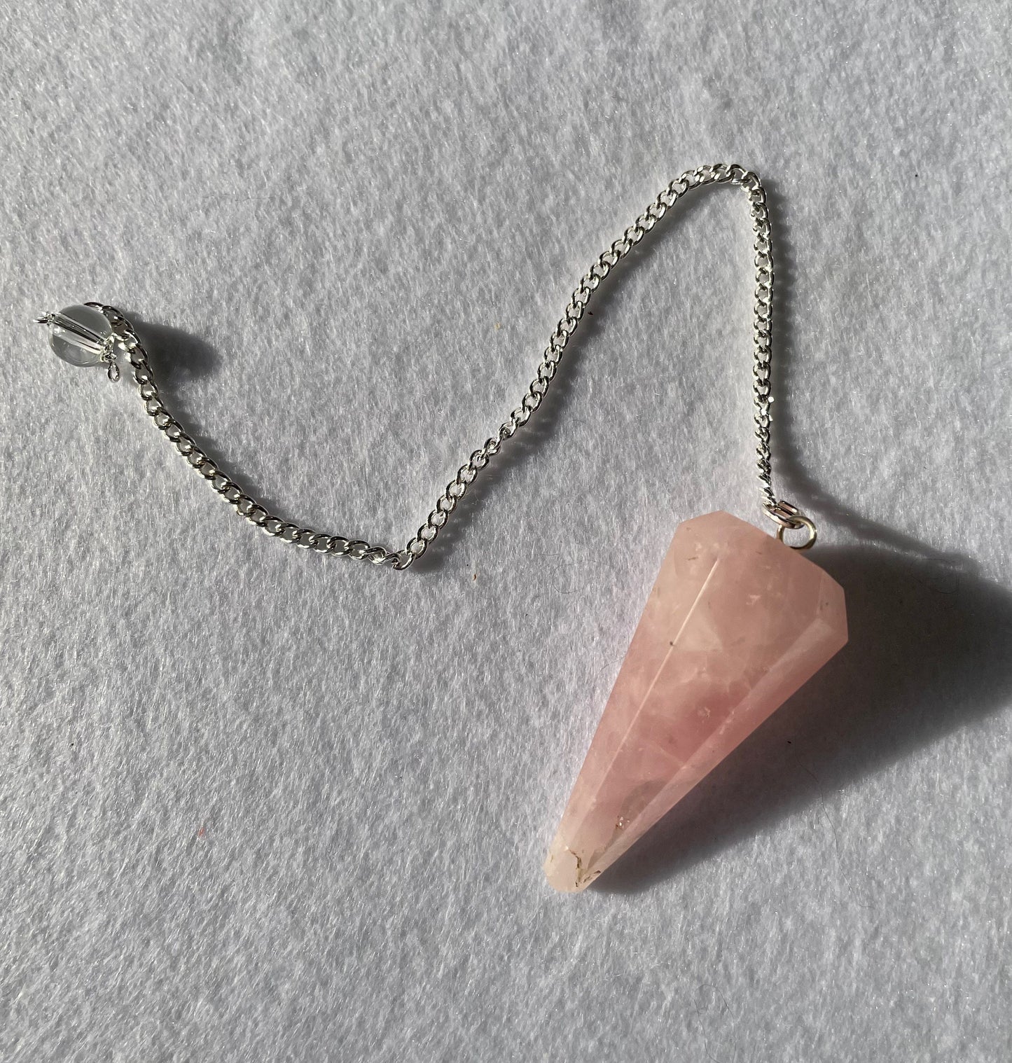 This beautiful Rose Quartz Pendulum is 1.65” and with chain is 8.5”.
