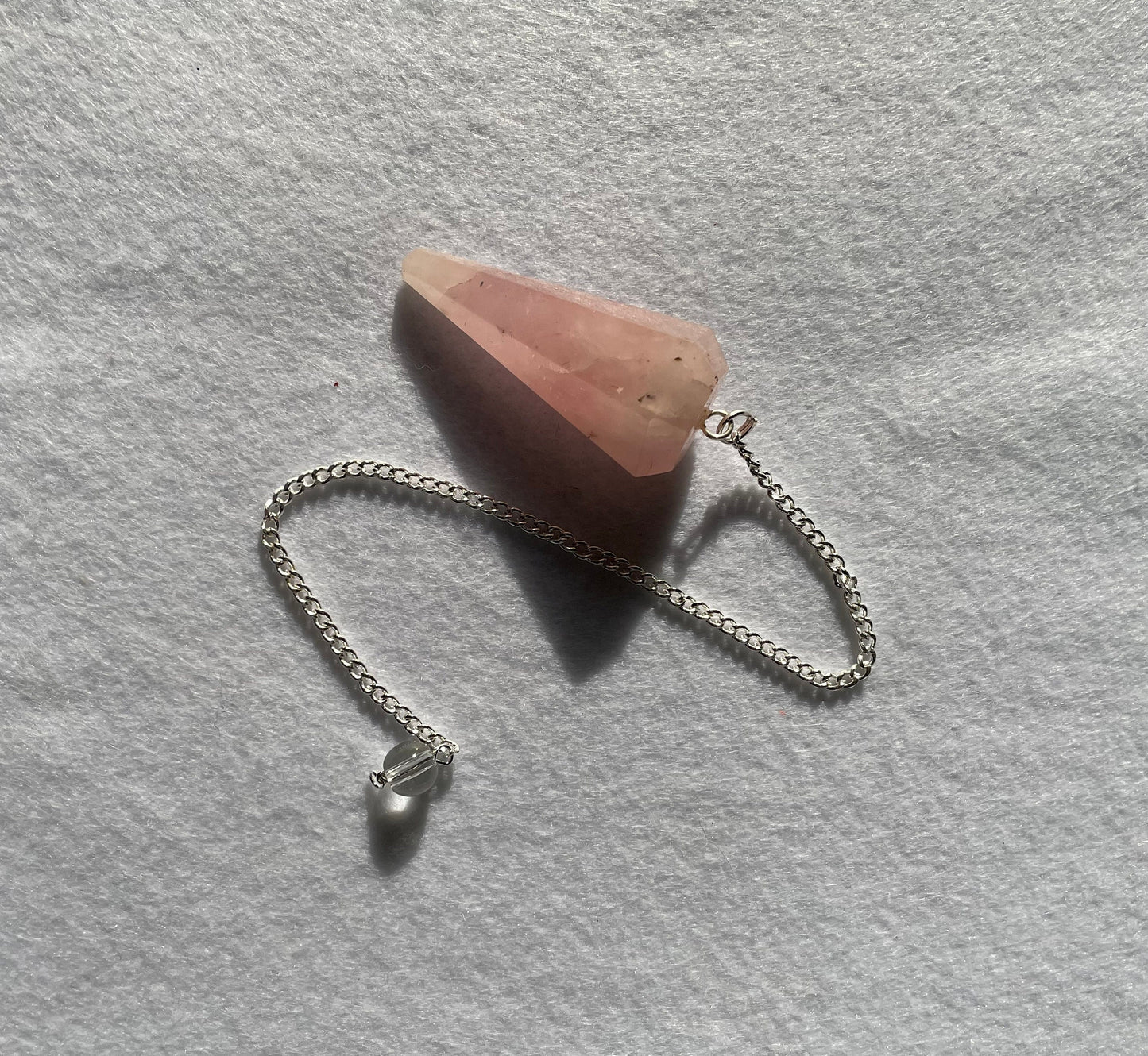 This beautiful Rose Quartz Pendulum is 1.65” and with chain is 8.5”.