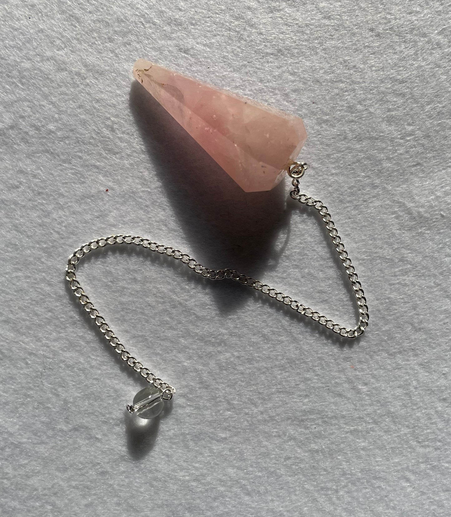 This beautiful Rose Quartz Pendulum is 1.65” and with chain is 8.5”.