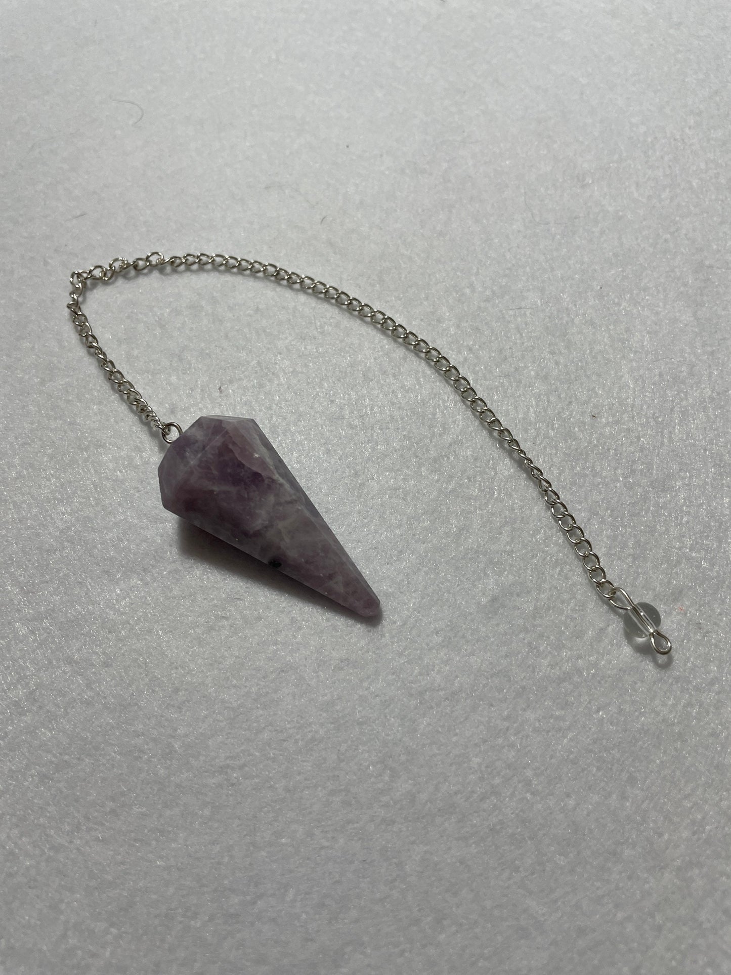This beautiful Lepidolite Pendulum is 1.65” and with chain is 9”