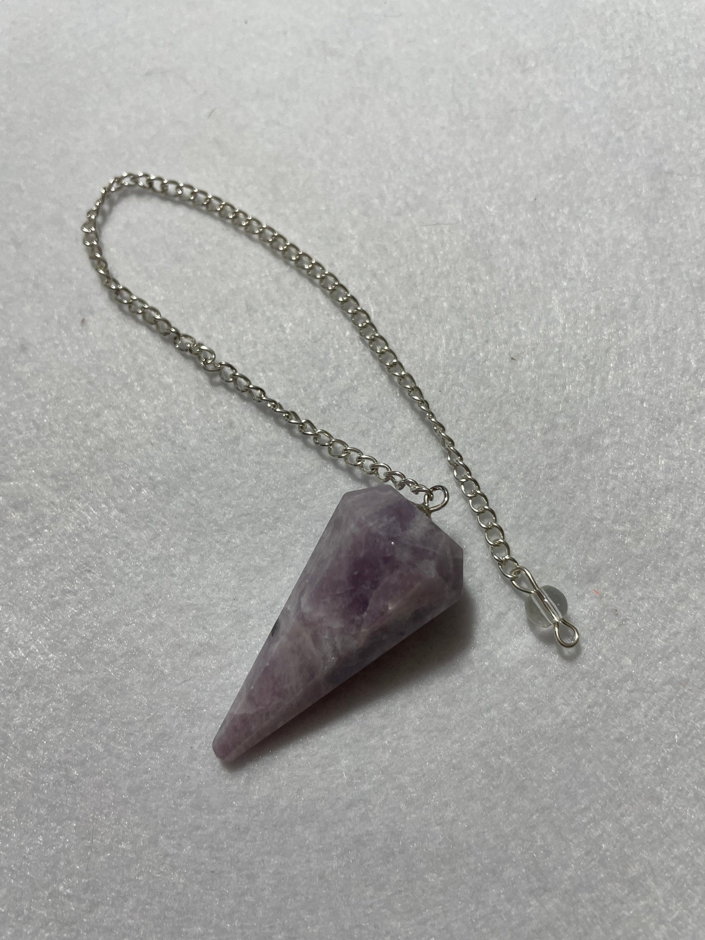 This beautiful Lepidolite Pendulum is 1.65” and with chain is 9”