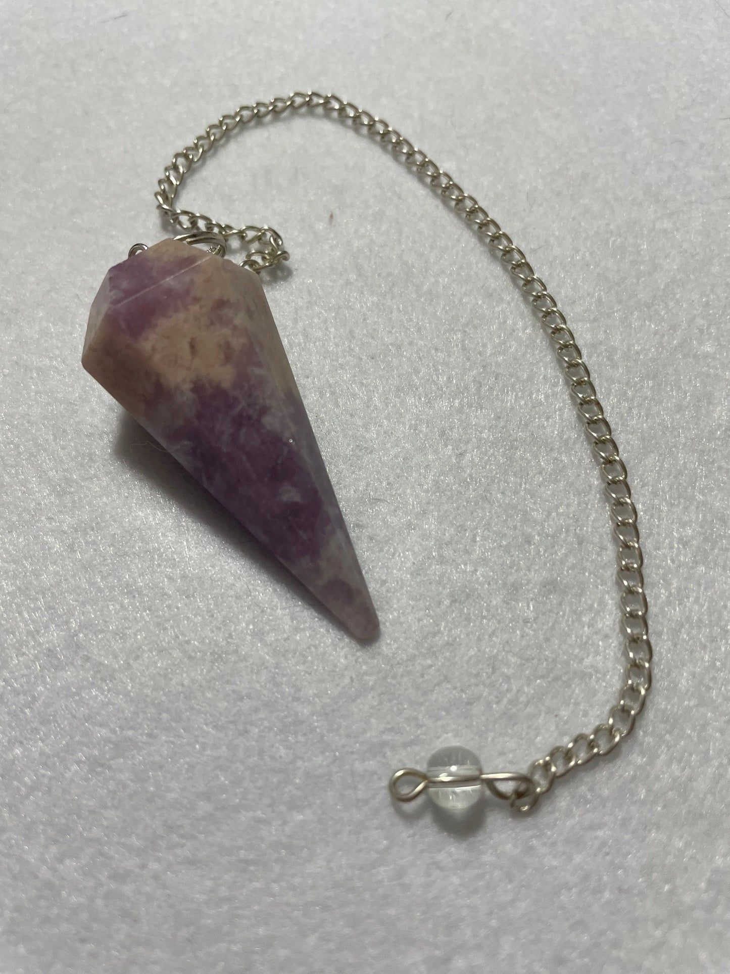 This magnificent pink and purple Lepidolite Pendulum is 1.75” and with chain is 9”.