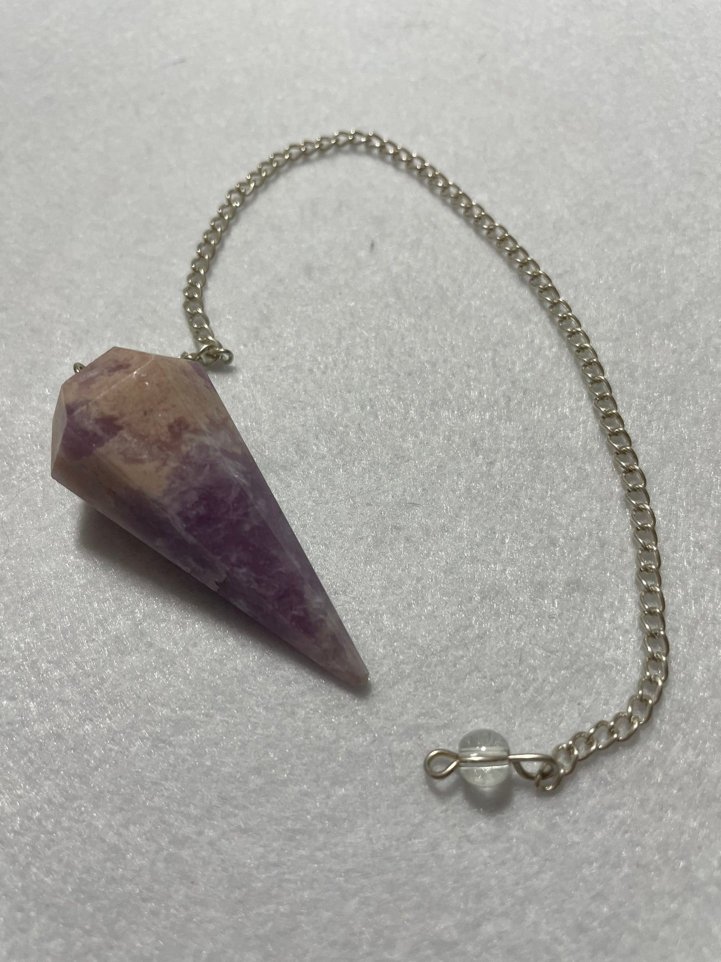 This magnificent pink and purple Lepidolite Pendulum is 1.75” and with chain is 9”.