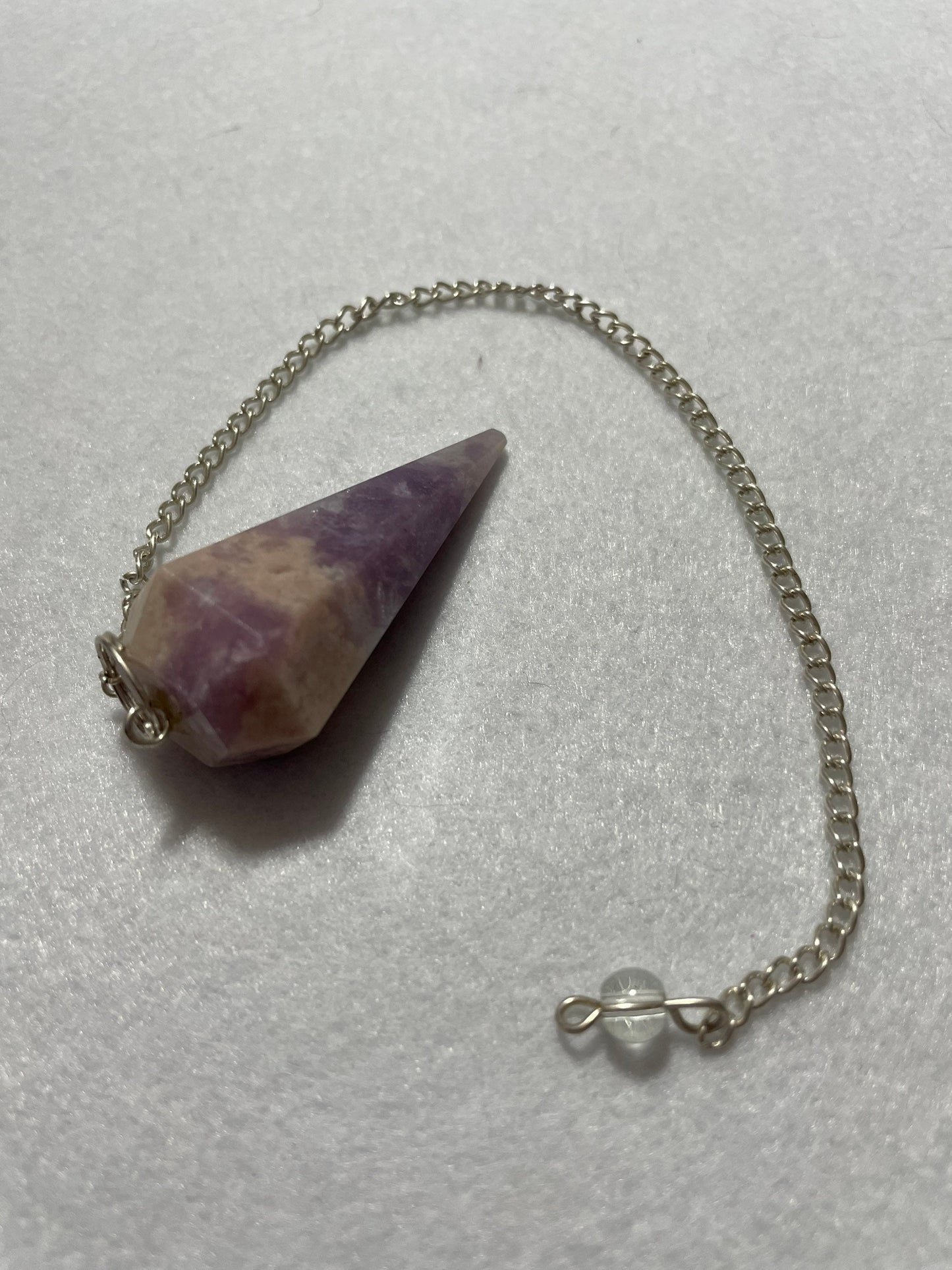 This magnificent pink and purple Lepidolite Pendulum is 1.75” and with chain is 9”.