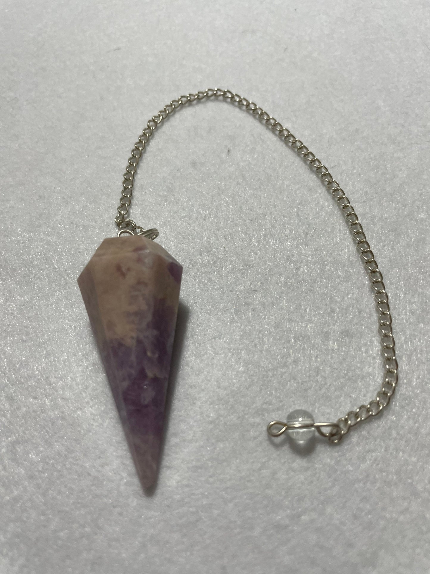 This magnificent pink and purple Lepidolite Pendulum is 1.75” and with chain is 9”.