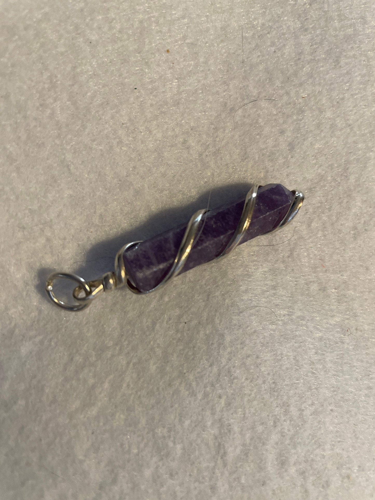 Gorgeous Amethyst Point Pendant is 1.50” and is wrapped in precious silver