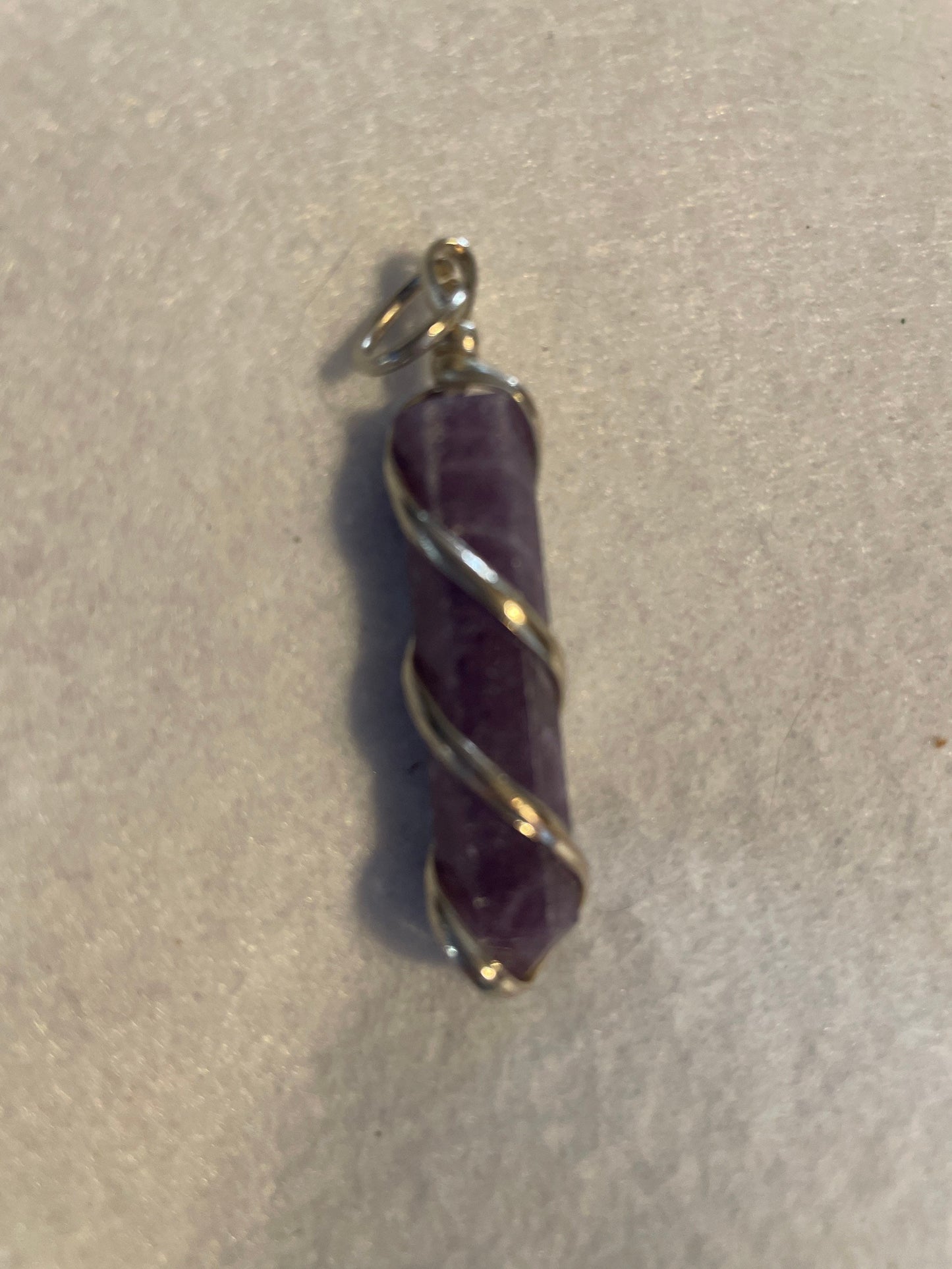 Gorgeous Amethyst Point Pendant is 1.50” and is wrapped in precious silver