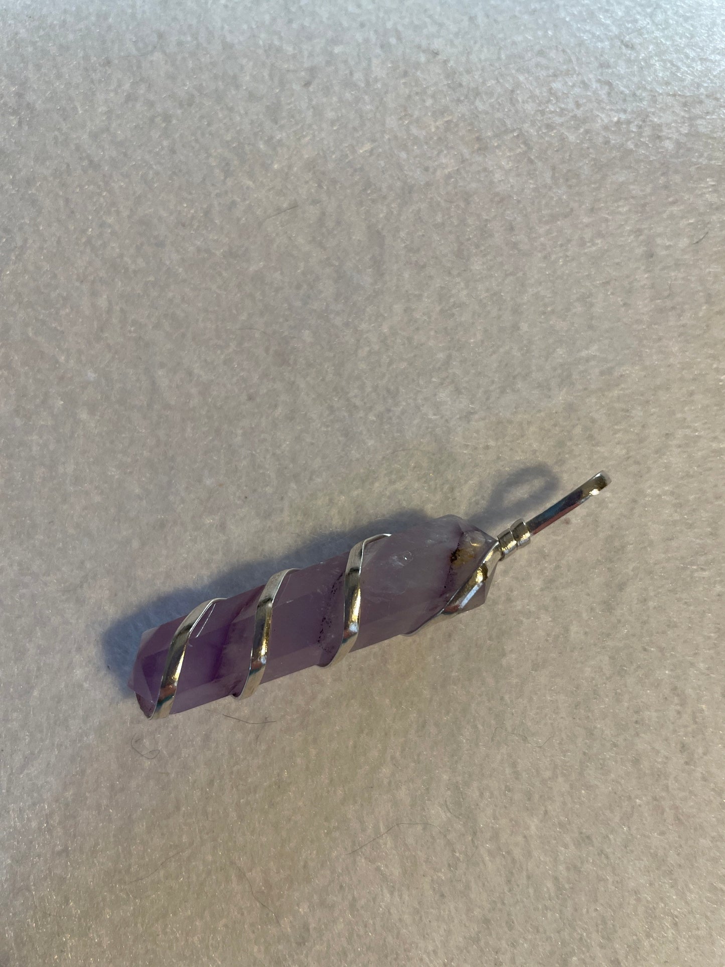 Gorgeous Amethyst Point Pendant is 1.5” and is wrapped in precious silver