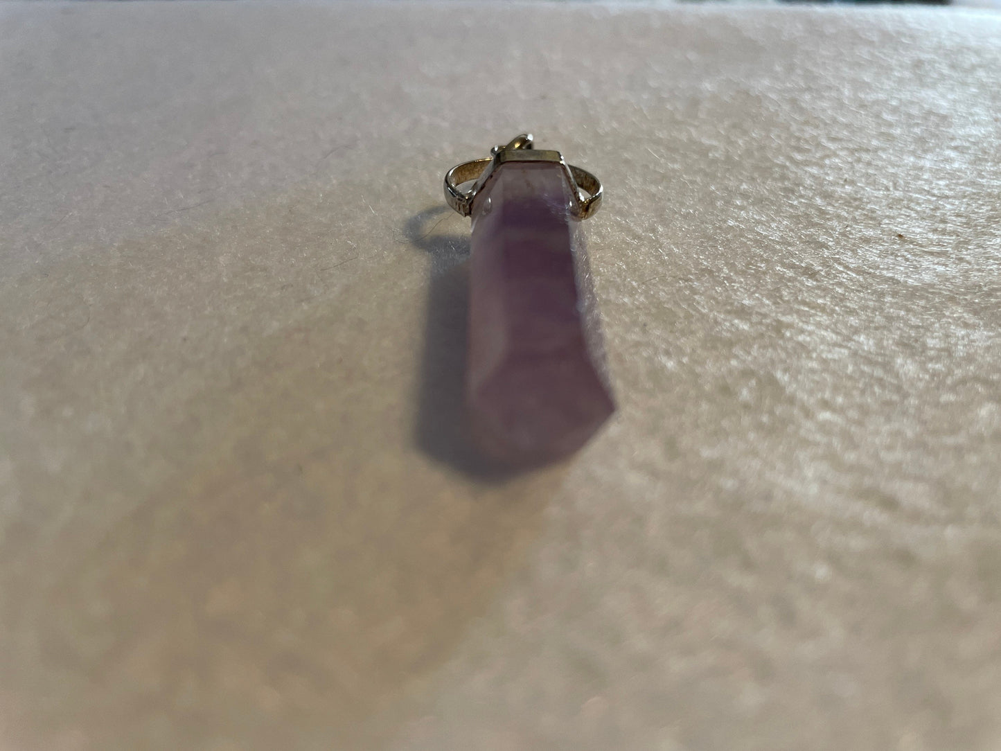 Gorgeous Amethyst Point Pendant is 1.5” and is attached to precious silver.