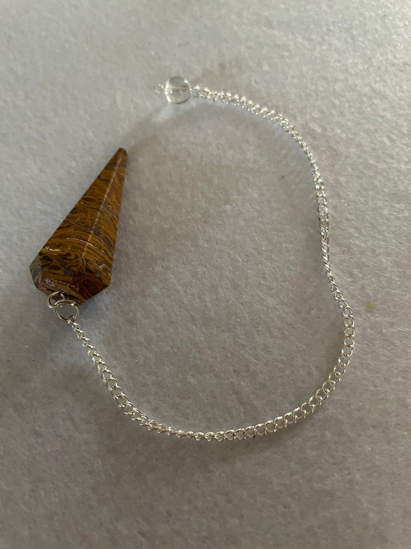 beautiful Yellow Jasper Pendulum is 1.50” and with the chain it is approximately 8”