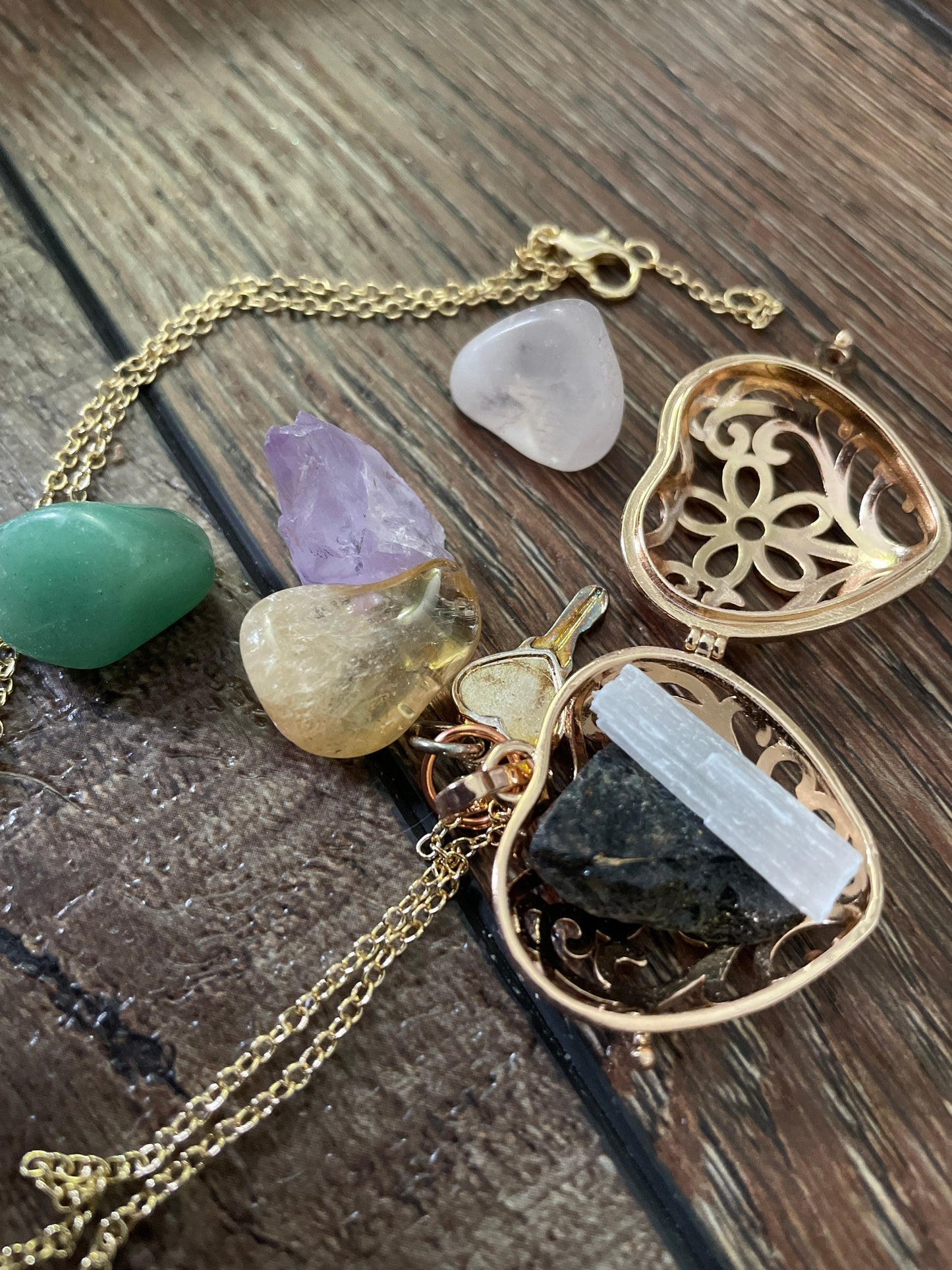 Gold locket filled with crystals on 16+” gold chain