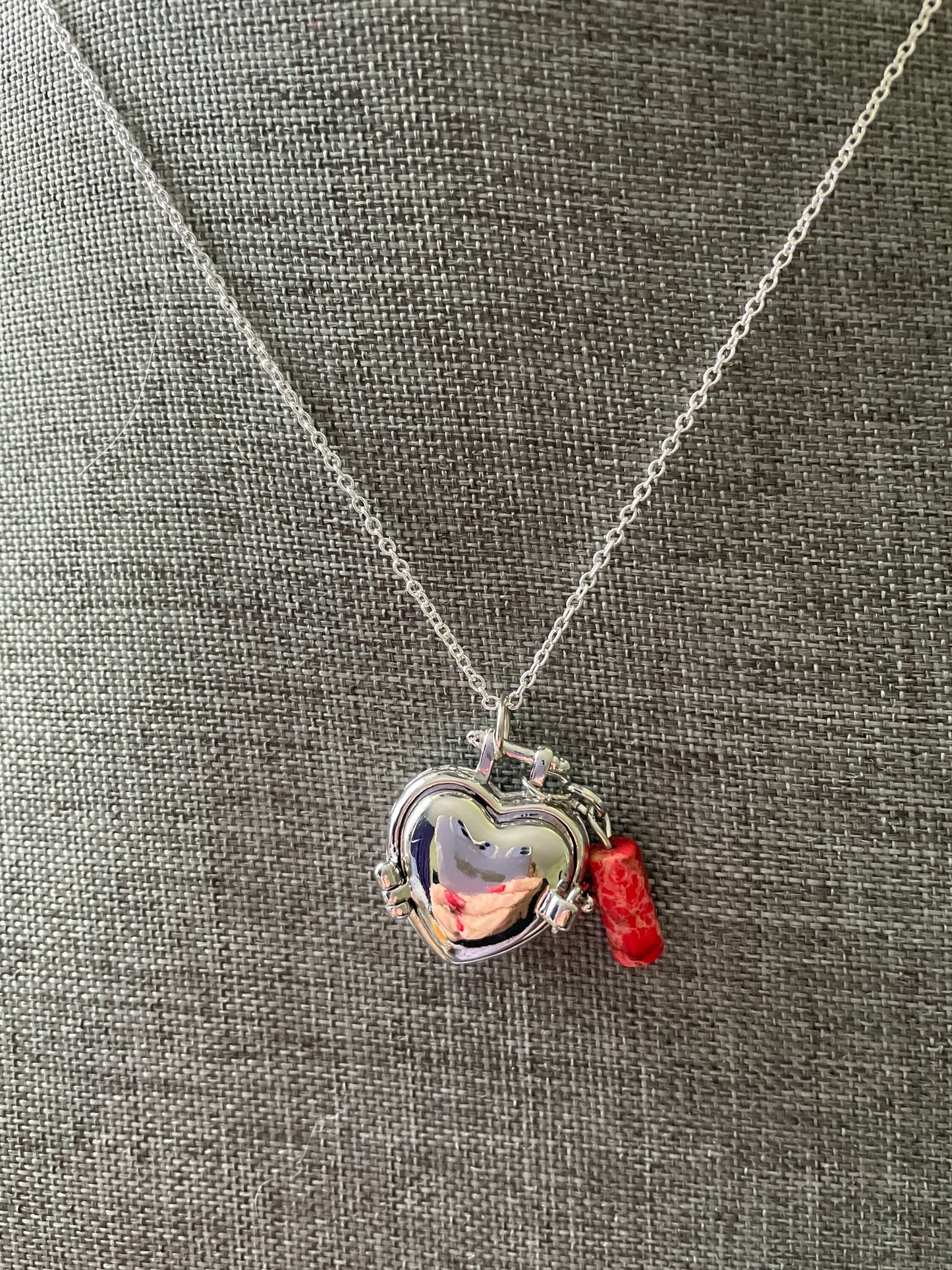 Silver stainless steel locket filled with crystals on 16+” silver stainless steel chain