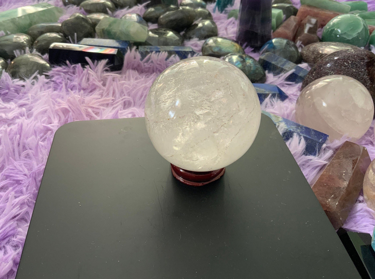 Beautiful 12.5 ounce clear quartz sphere crystal ball with wooden stand