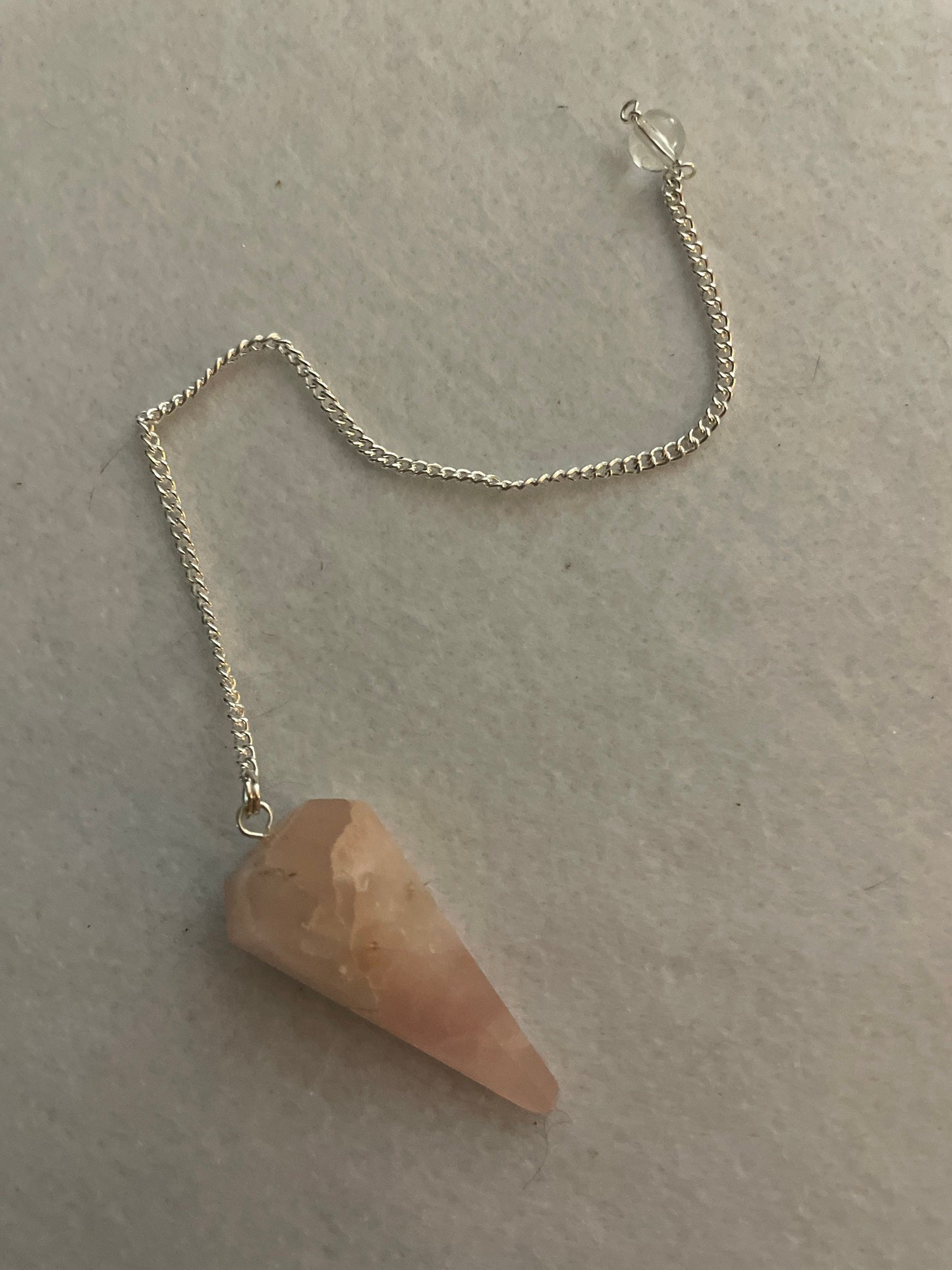 This beautiful Rose Quartz Pendulum is 1.65” and with chain is 8”