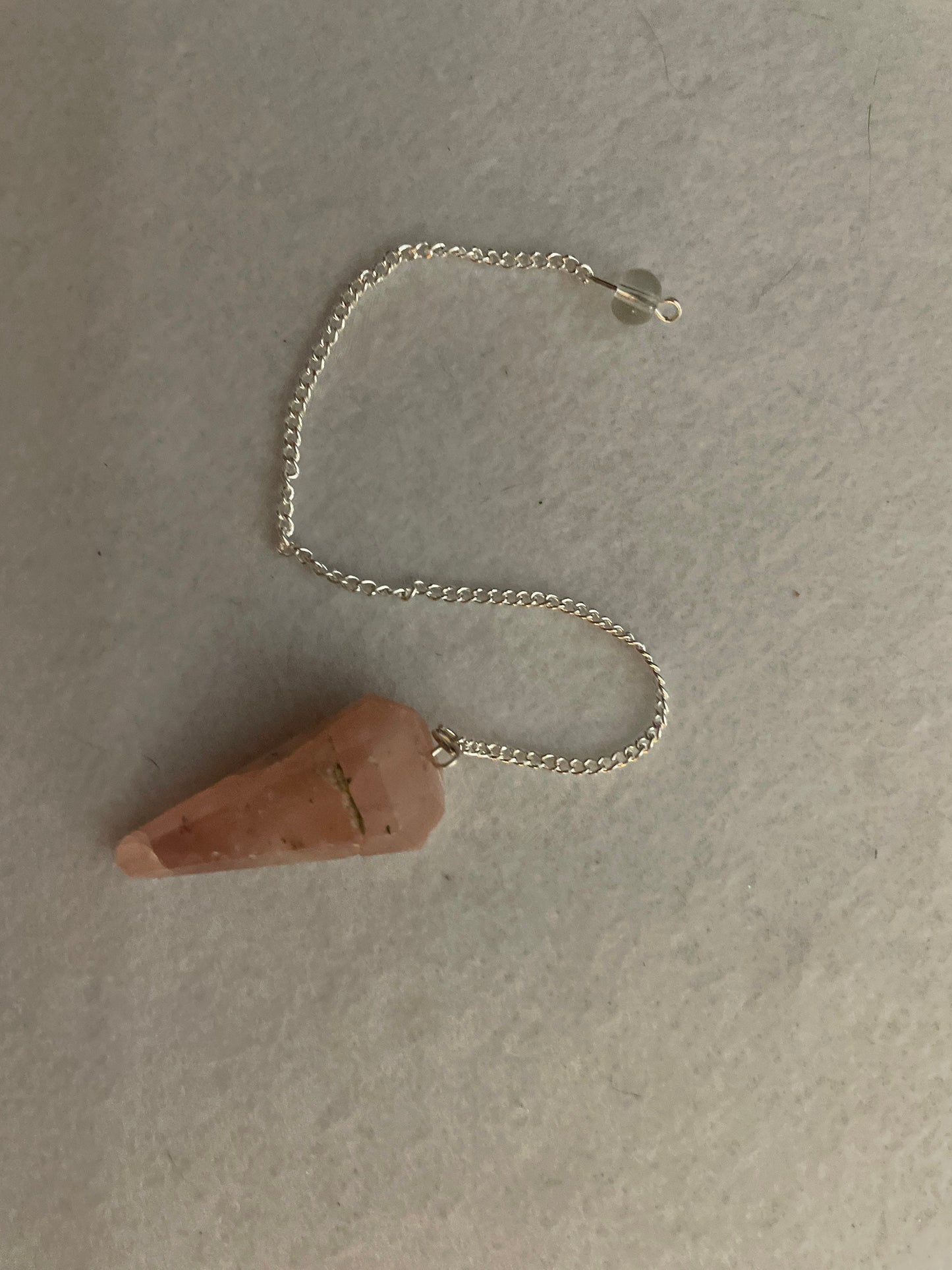 This beautiful Rose Quartz Pendulum is 1.65” and with chain is 8”.