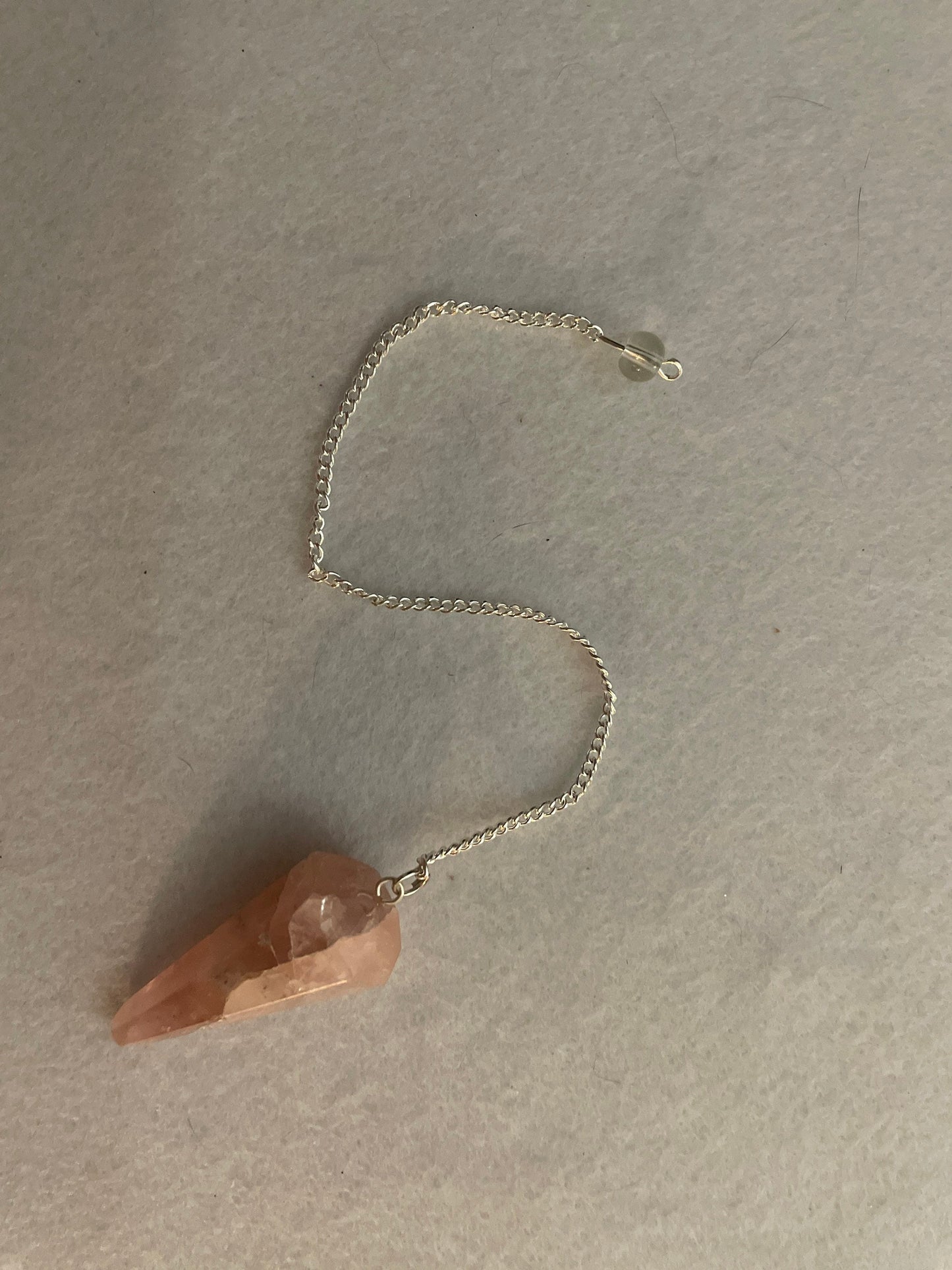 This beautiful Rose Quartz Pendulum is 1.65” and with chain is 8”.
