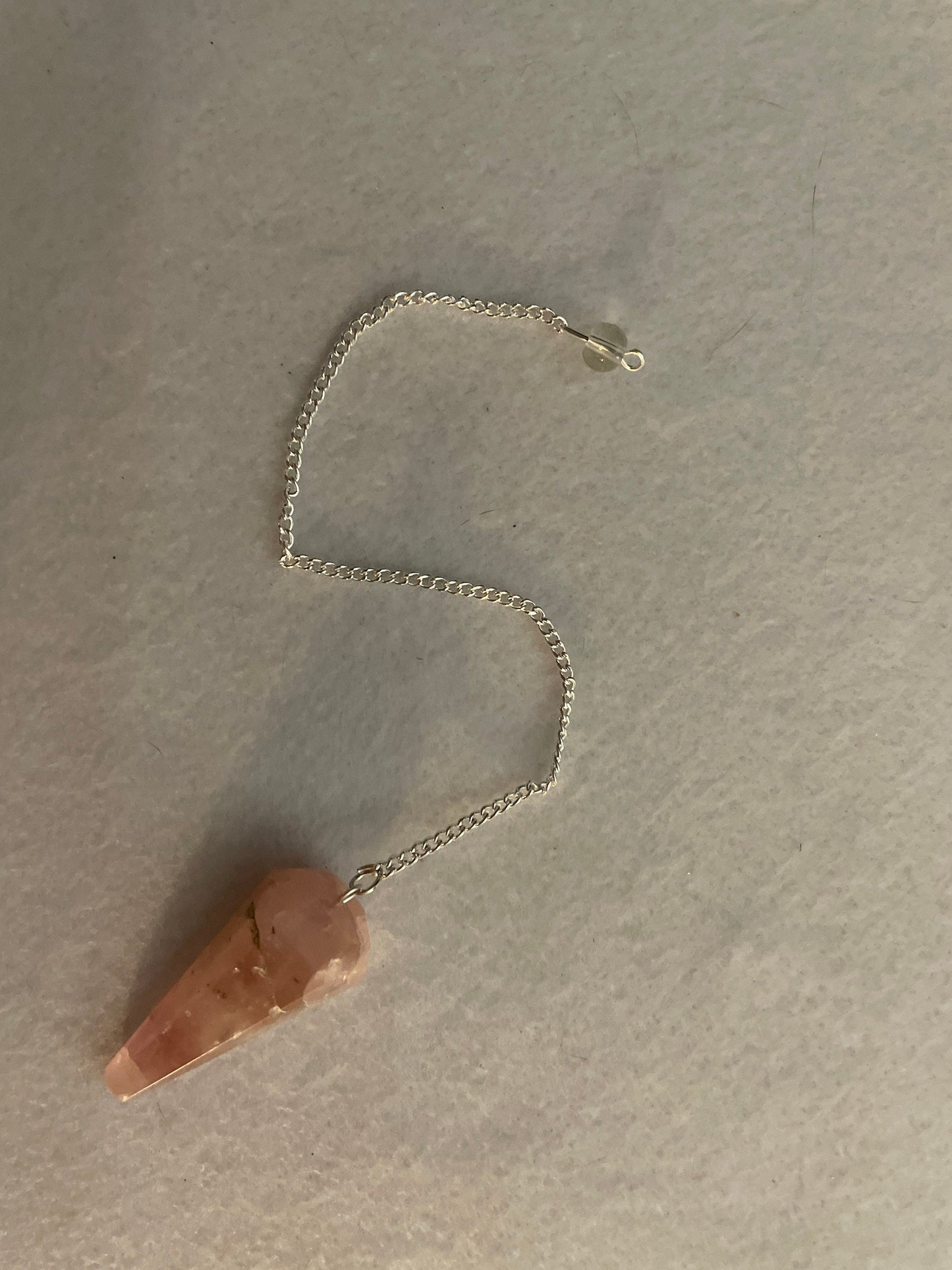 This beautiful Rose Quartz Pendulum is 1.65” and with chain is 8”.