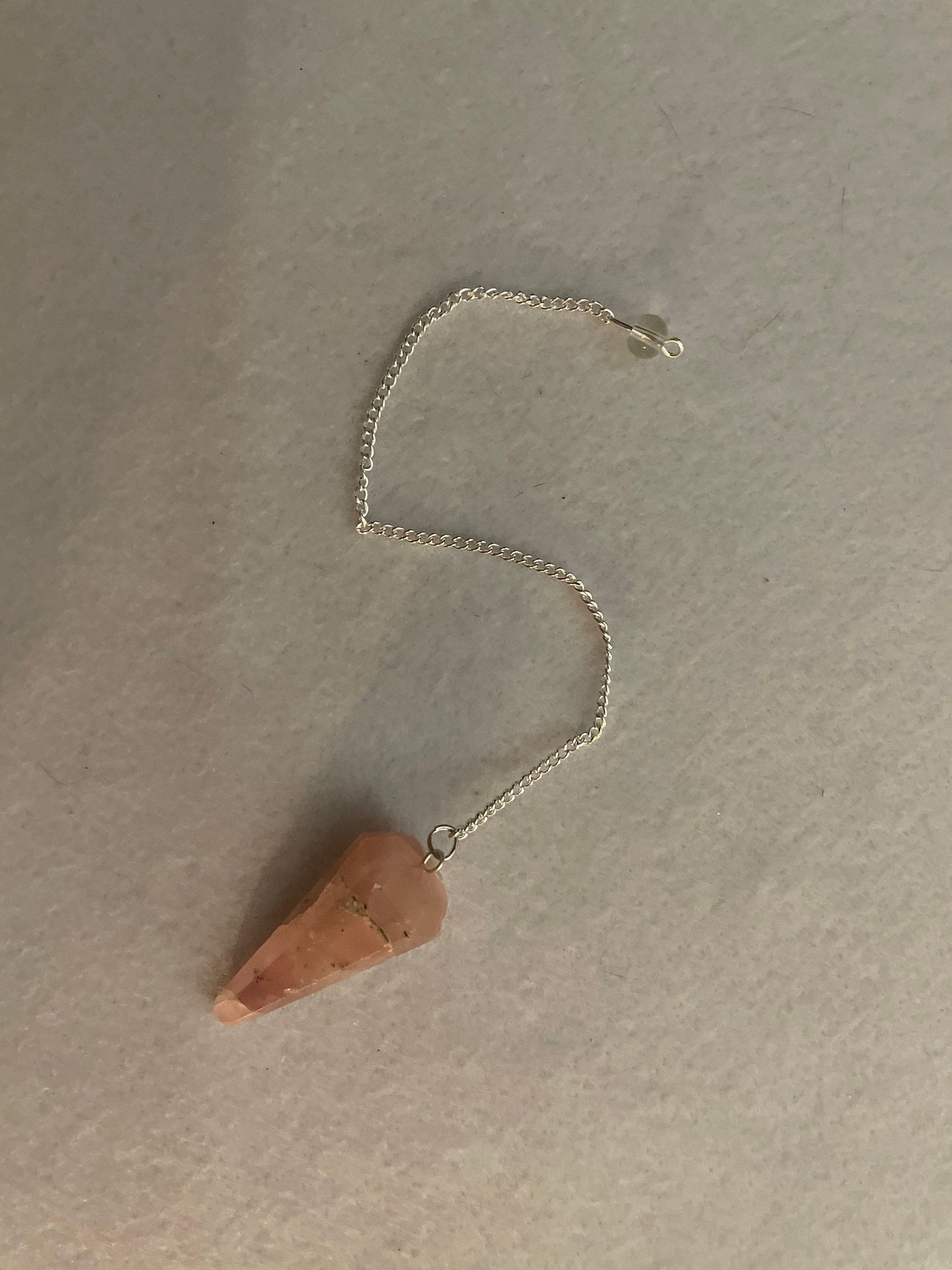 This beautiful Rose Quartz Pendulum is 1.65” and with chain is 8”.