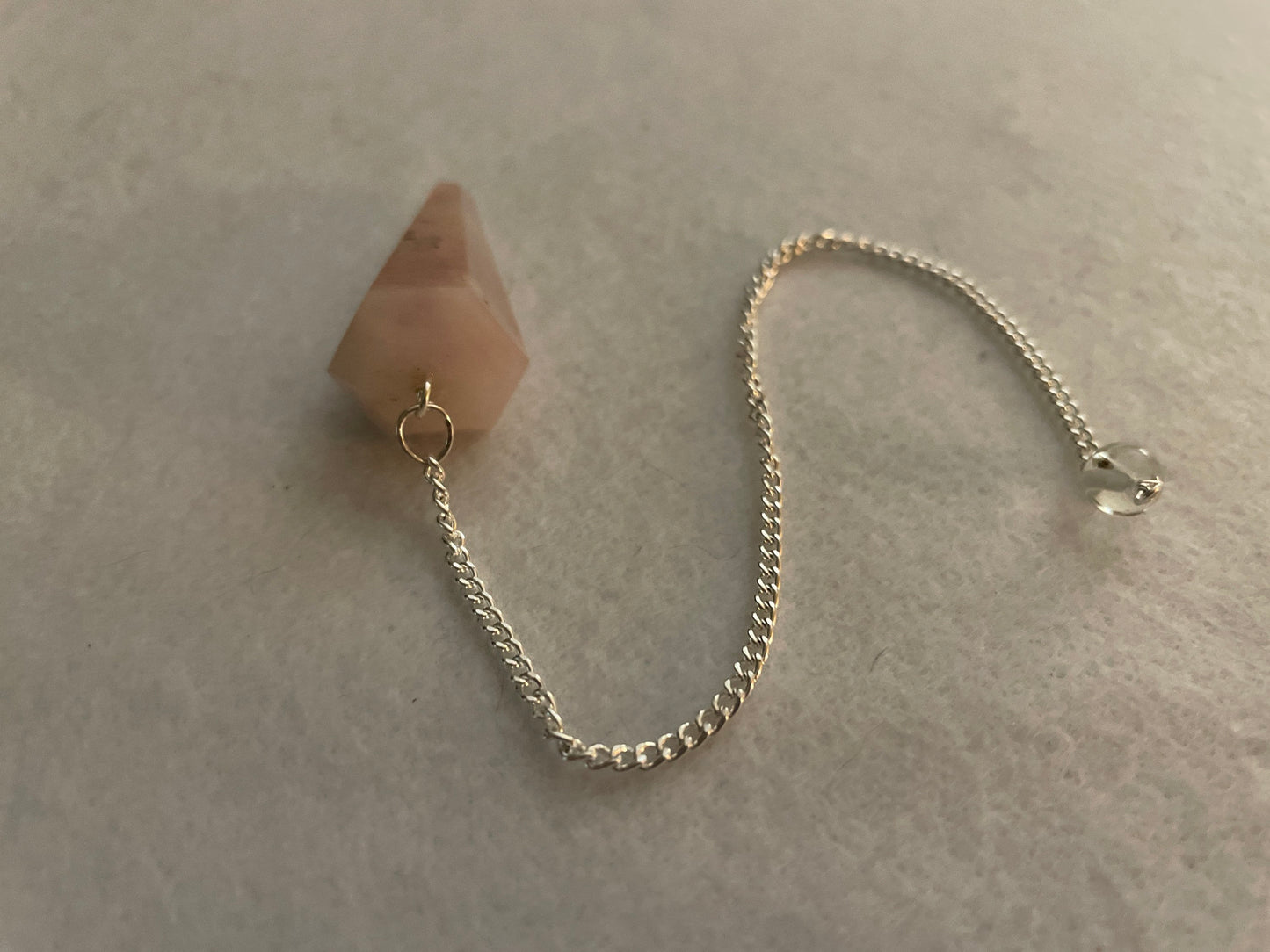 This beautiful Rose Quartz Pendulum is 1.65” and with chain is 8”