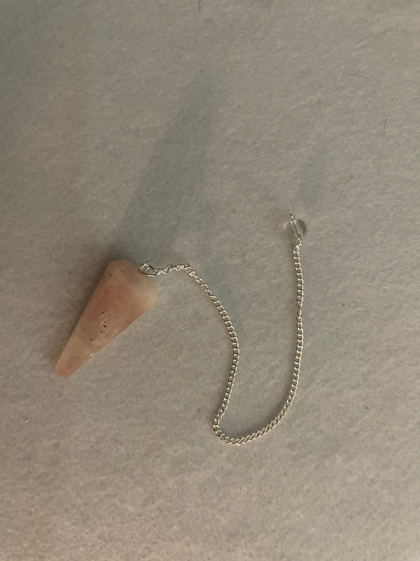 This beautiful Rose Quartz Pendulum is 1.65” and with chain is 8”