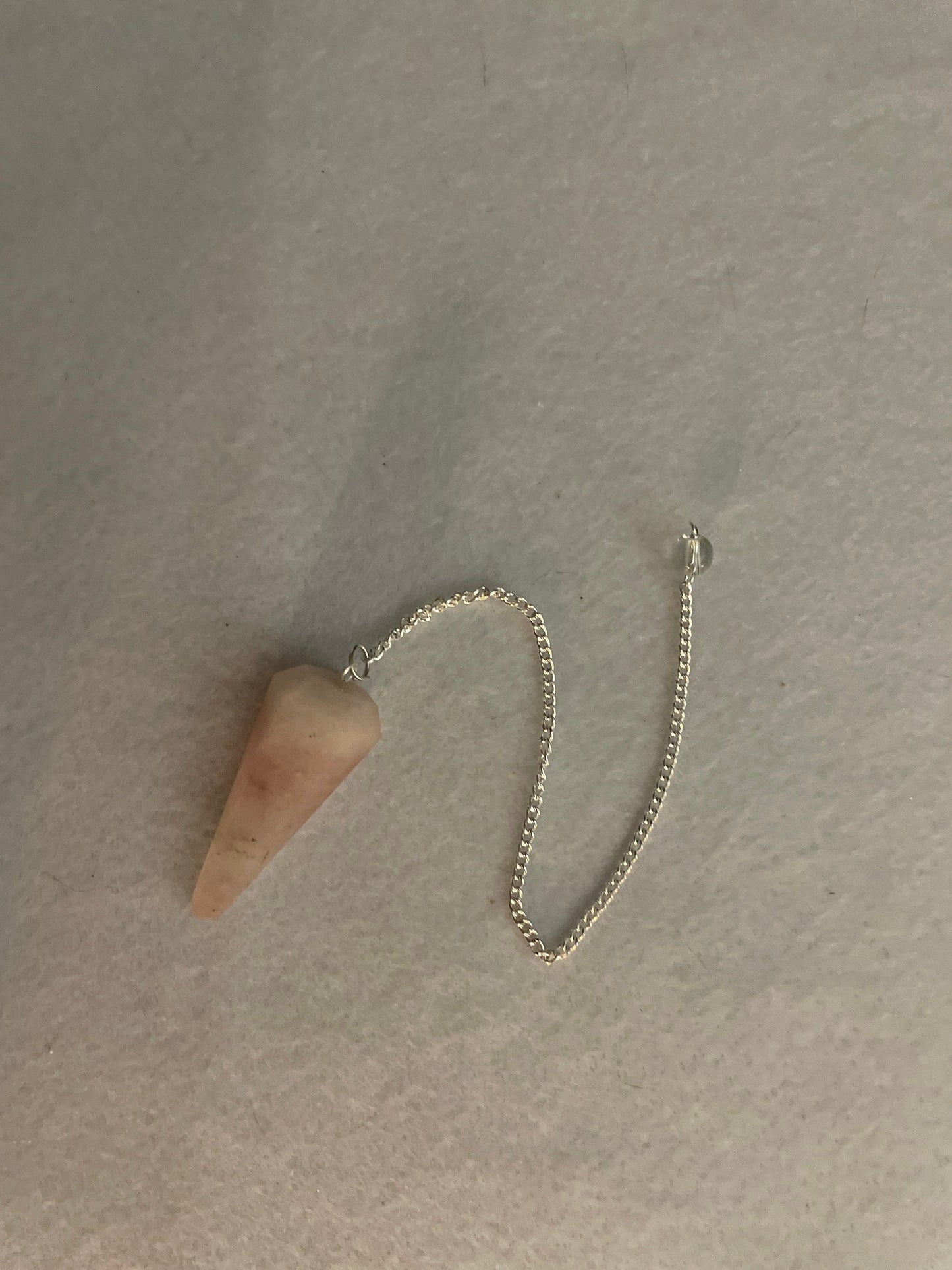 This beautiful Rose Quartz Pendulum is 1.65” and with chain is 8”