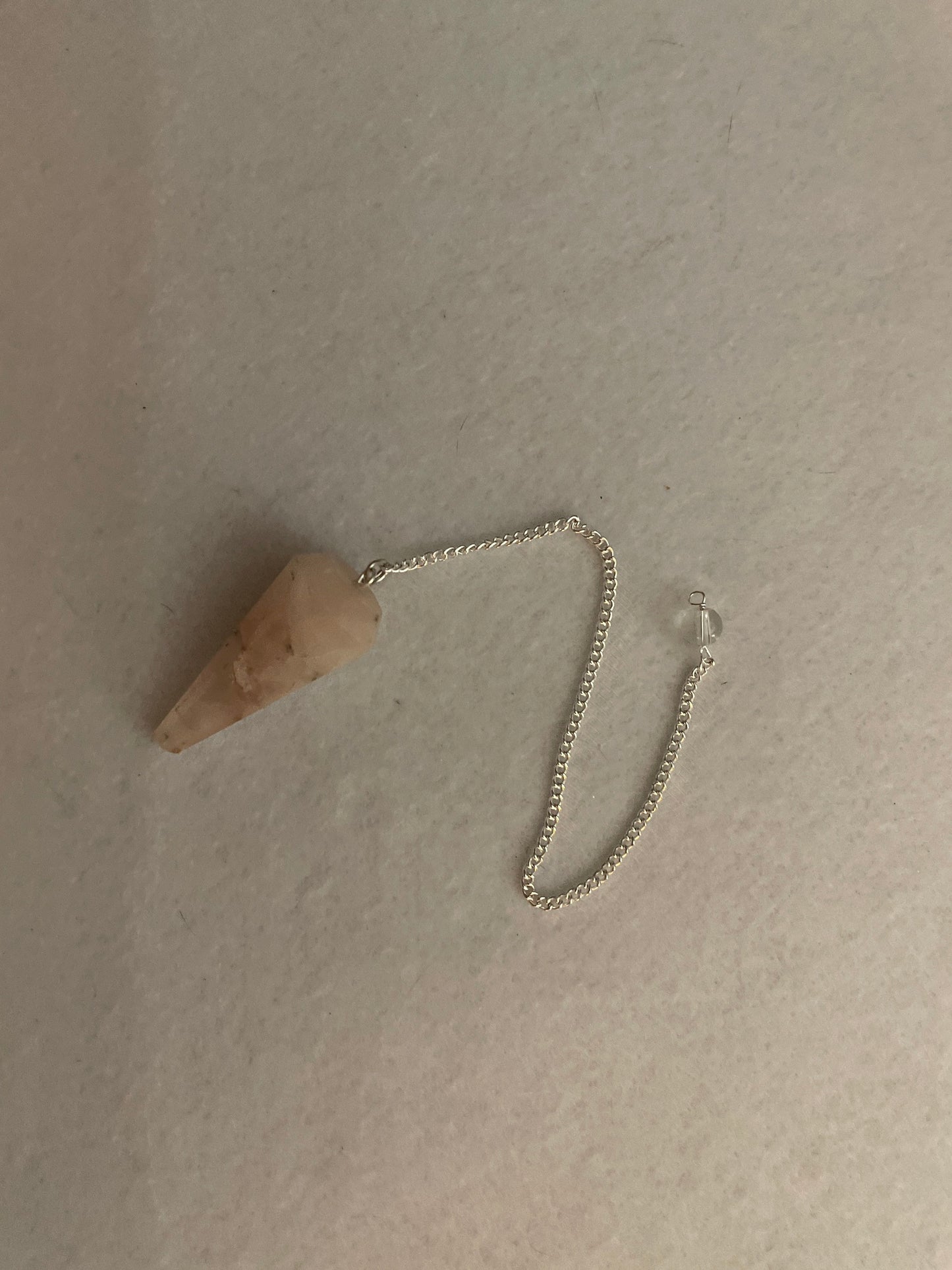 This beautiful Rose Quartz Pendulum is 1.65” and with chain is 8.25”