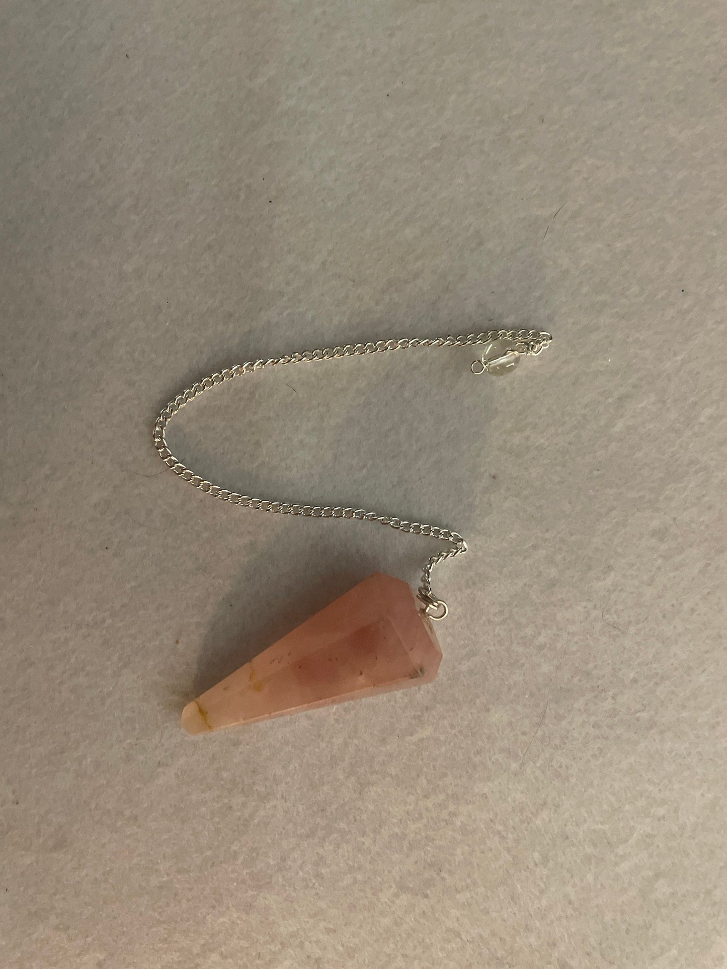 This beautiful Rose Quartz Pendulum is 1.85” and with chain is 8.25”