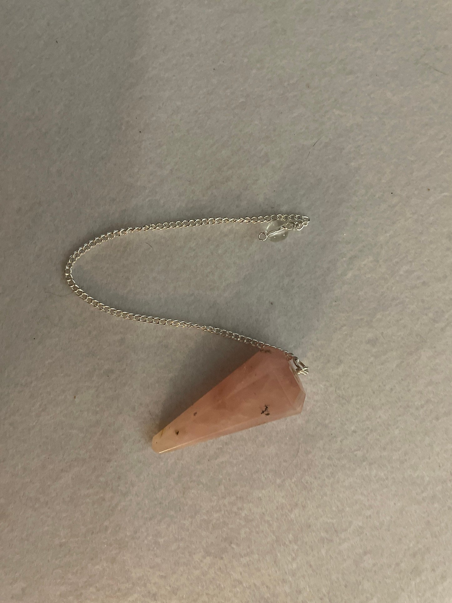 This beautiful Rose Quartz Pendulum is 1.85” and with chain is 8.25”