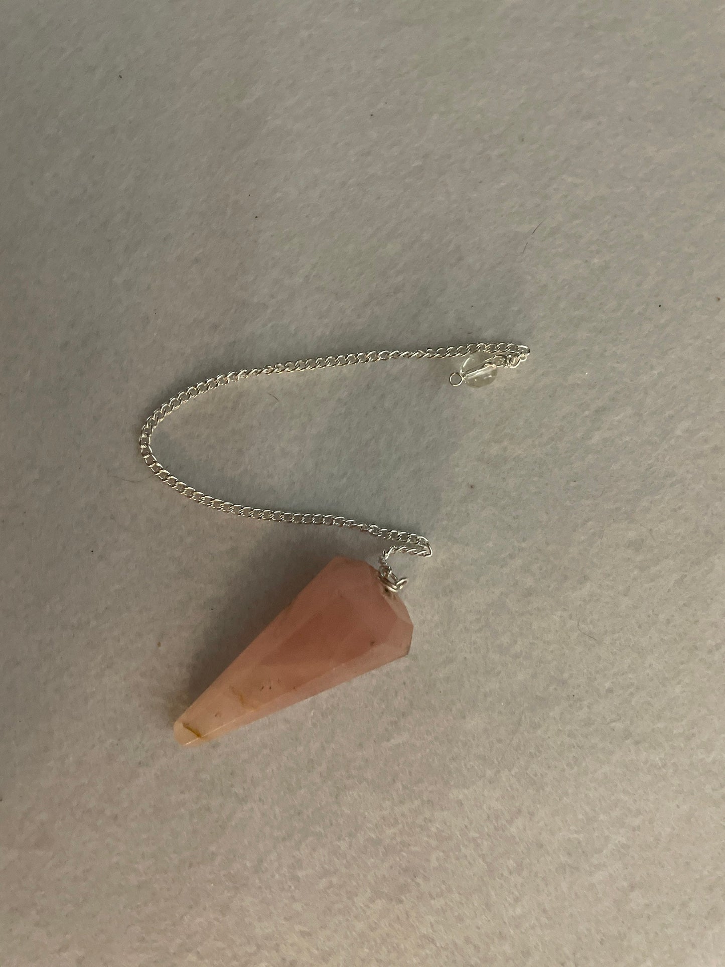 This beautiful Rose Quartz Pendulum is 1.85” and with chain is 8.25”