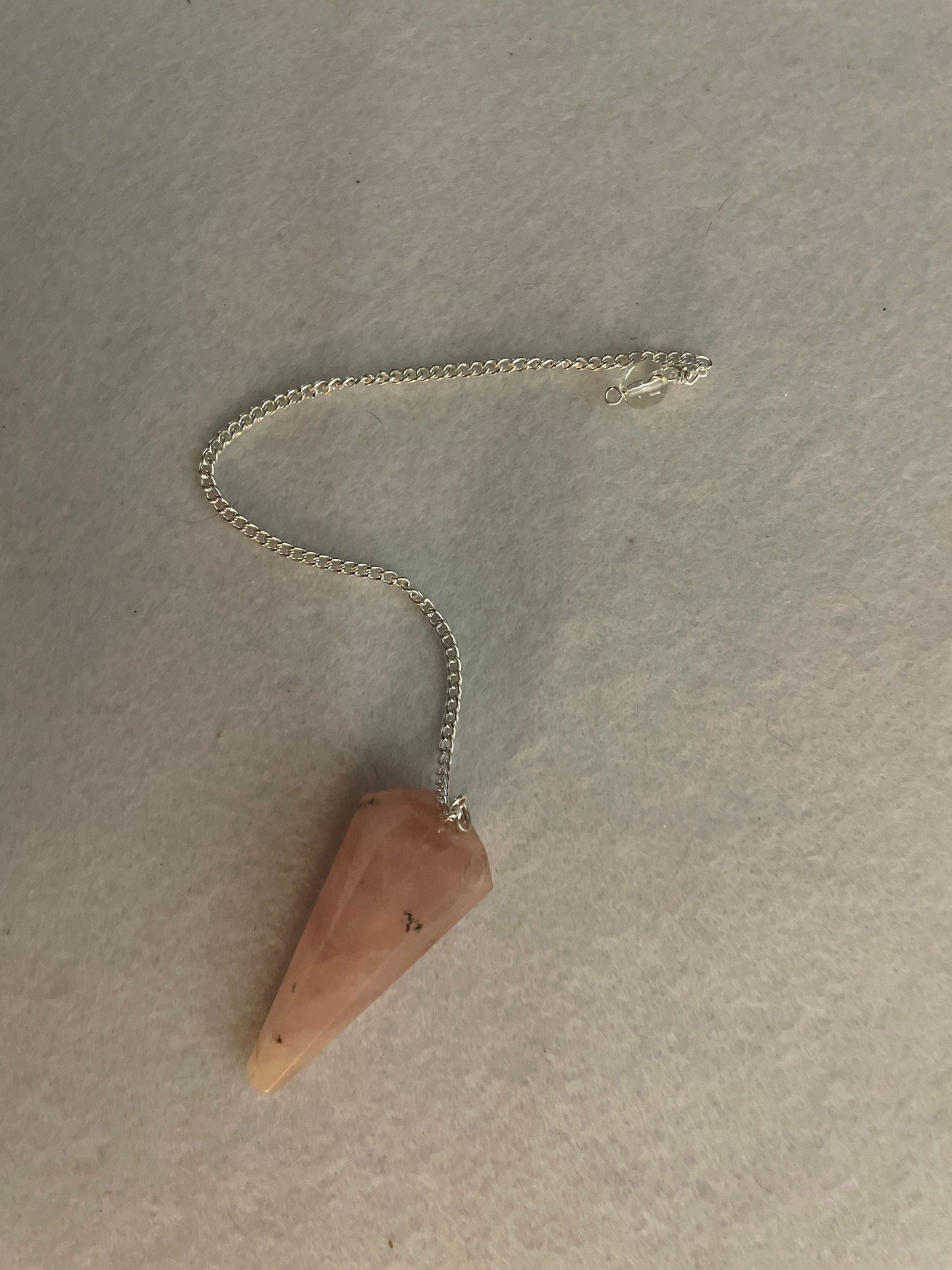 This beautiful Rose Quartz Pendulum is 1.85” and with chain is 8.25”