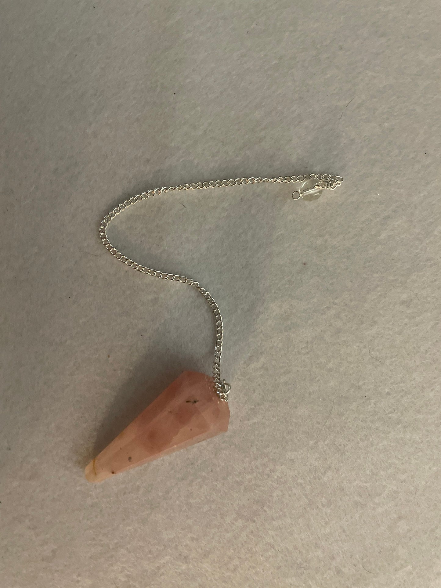 This beautiful Rose Quartz Pendulum is 1.85” and with chain is 8.25”