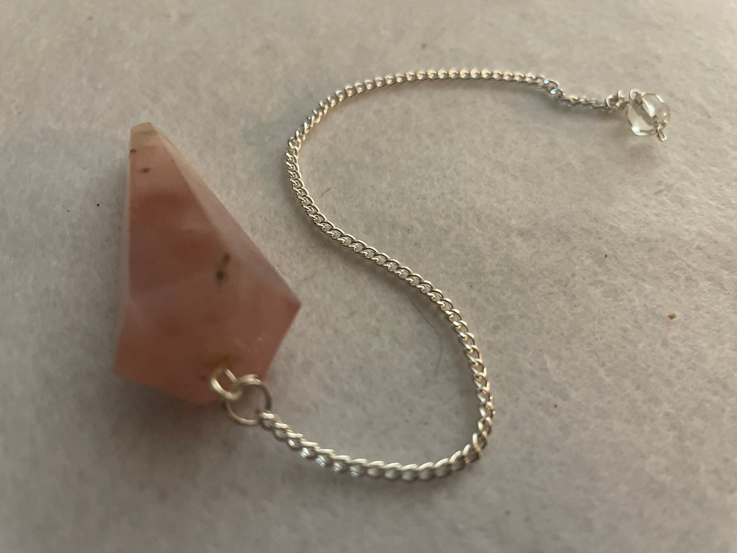 This beautiful Rose Quartz Pendulum is 1.85” and with chain is 8.25”
