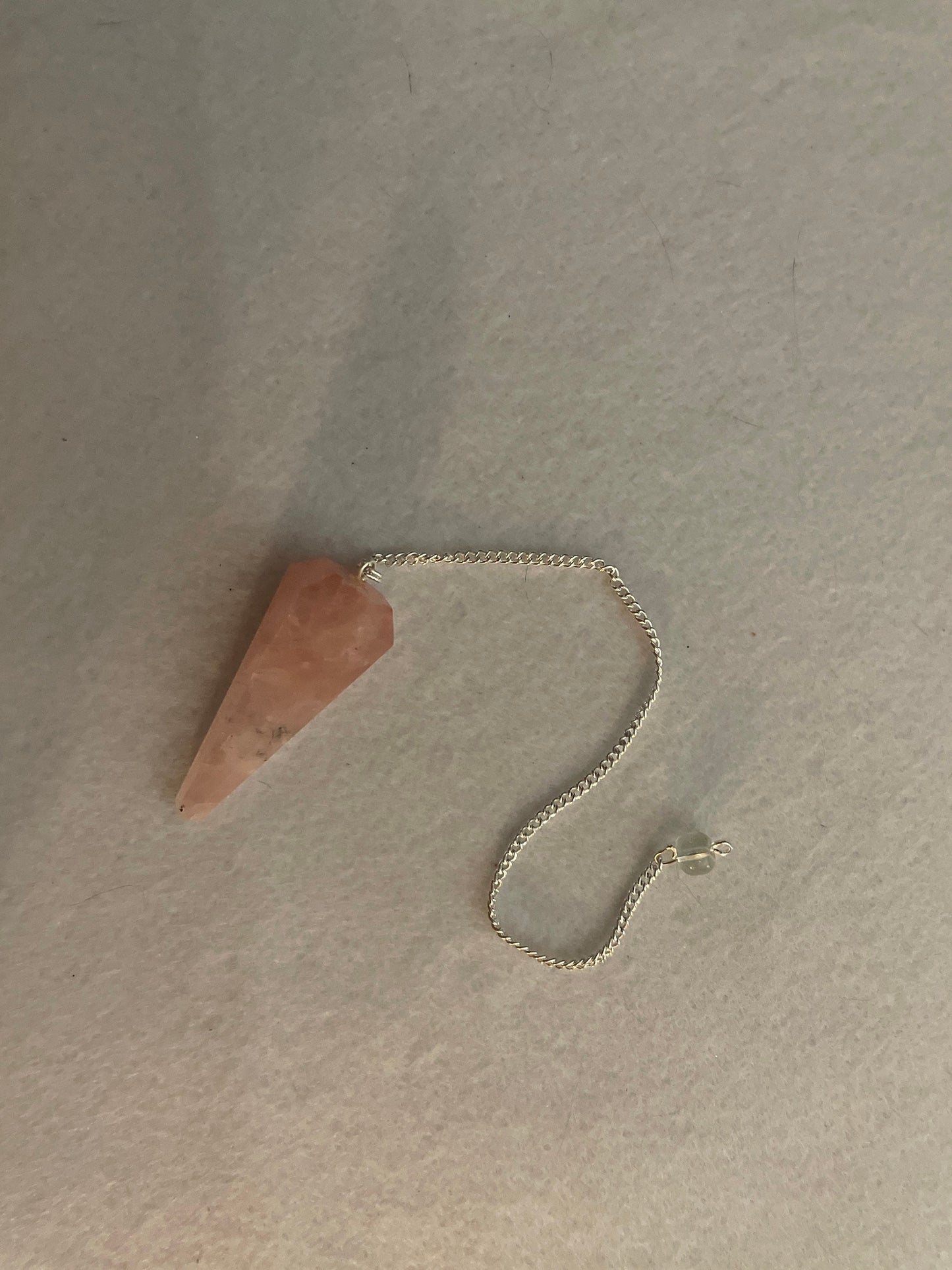 This beautiful Rose Quartz Pendulum is 1.85” and with chain is 8.25”