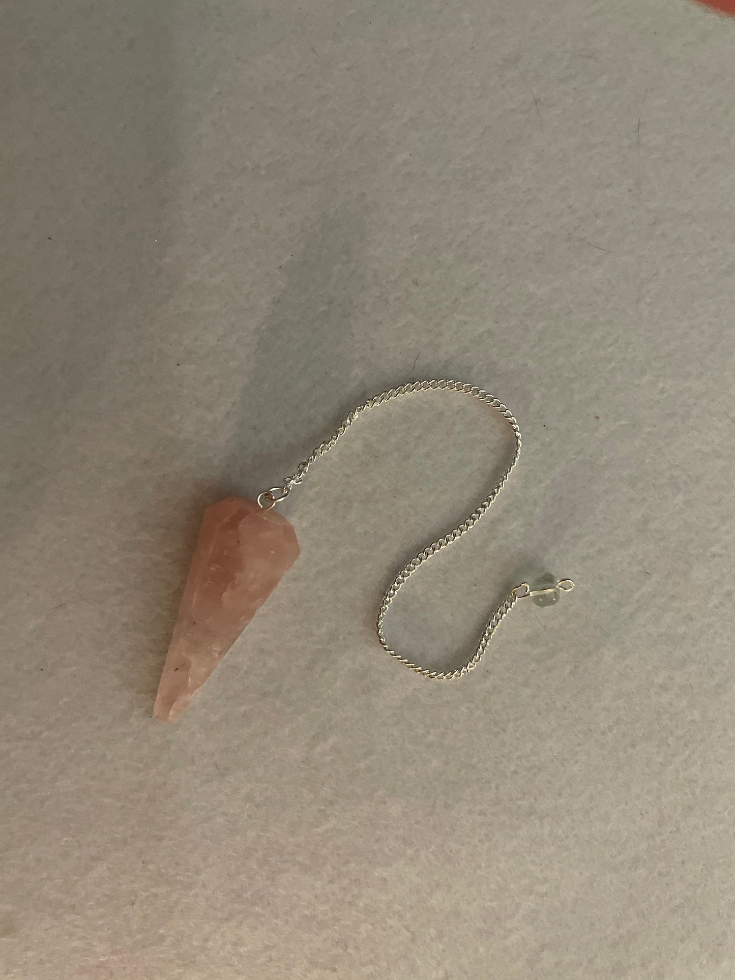 This beautiful Rose Quartz Pendulum is 1.85” and with chain is 8.25”