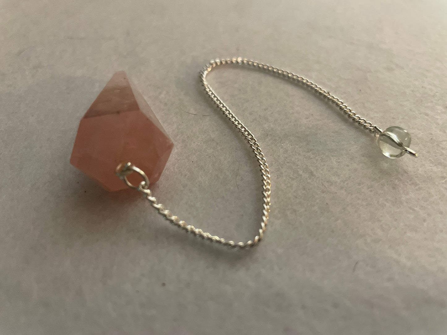 This beautiful Rose Quartz Pendulum is 1.85” and with chain is 8.25”