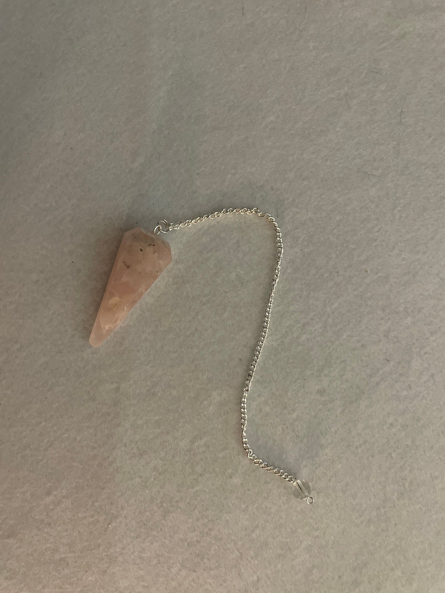 This beautiful Rose Quartz Pendulum is 1.75” and with chain is 8”.