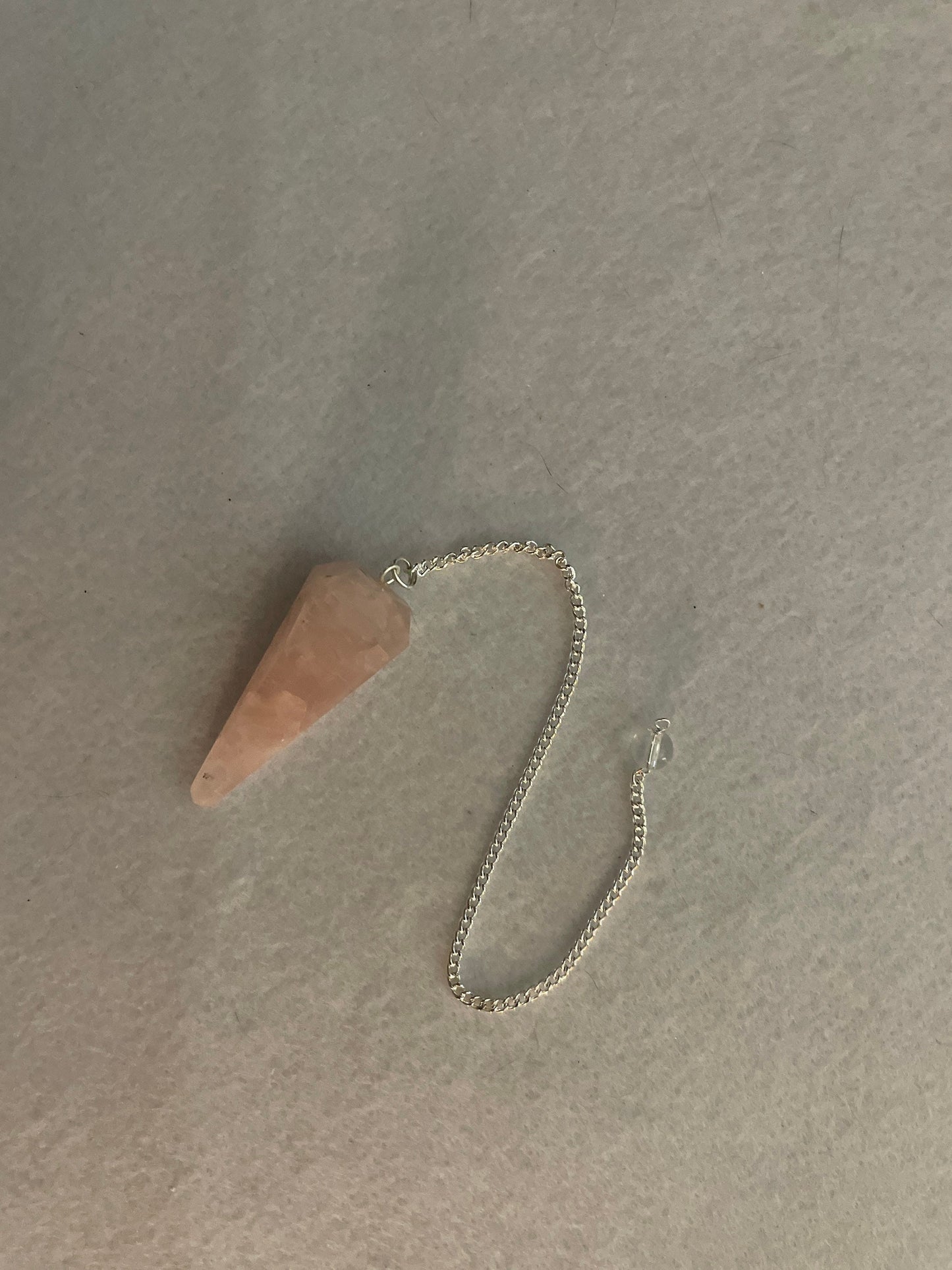 This beautiful Rose Quartz Pendulum is 1.75” and with chain is 8”.