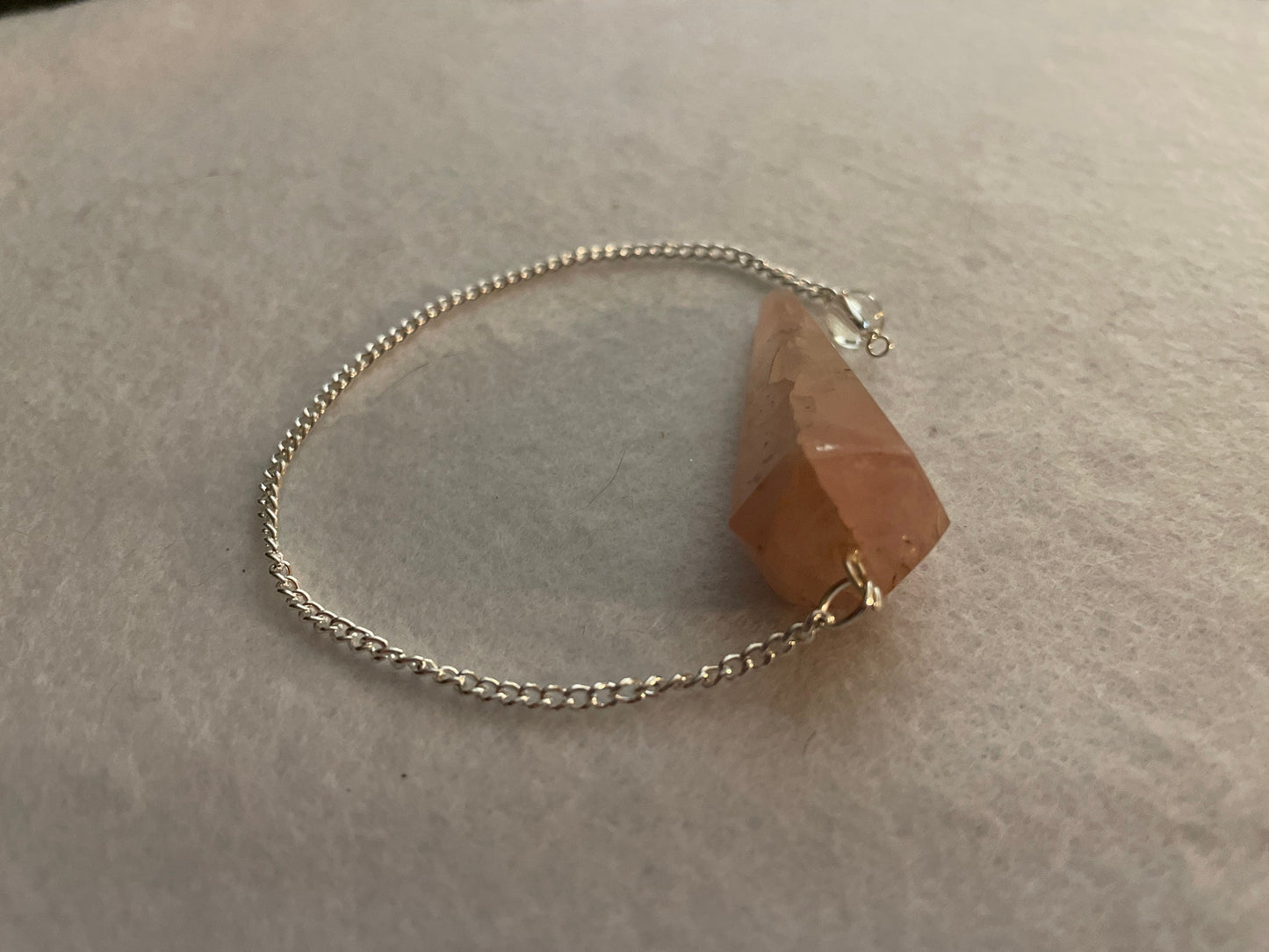 This beautiful Rose Quartz Pendulum is 1.75” and with chain is 8.25”