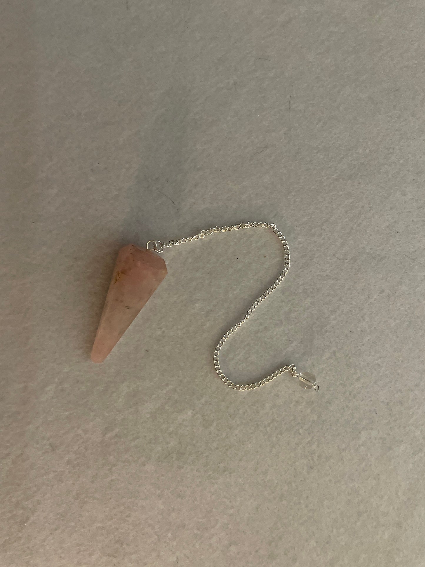 This beautiful Rose Quartz Pendulum is 1.75” and with chain is 8.25”