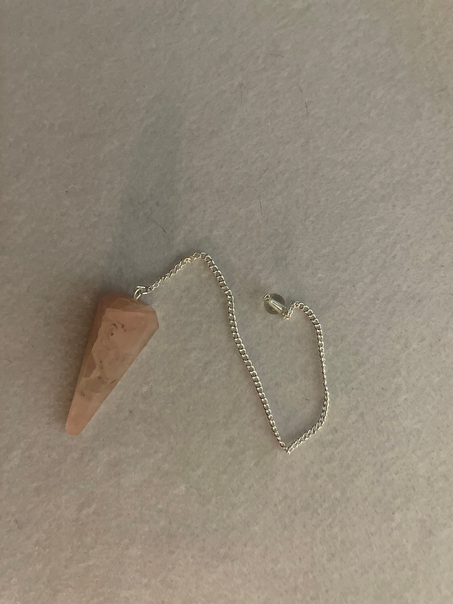 This beautiful Rose Quartz Pendulum is 1.75” and with chain is 8.25”