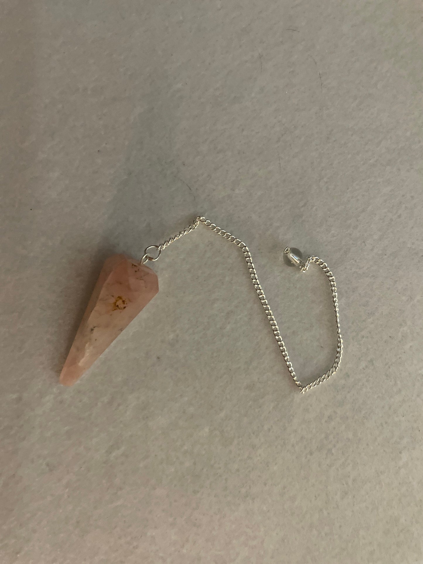 This beautiful Rose Quartz Pendulum is 1.75” and with chain is 8.25”