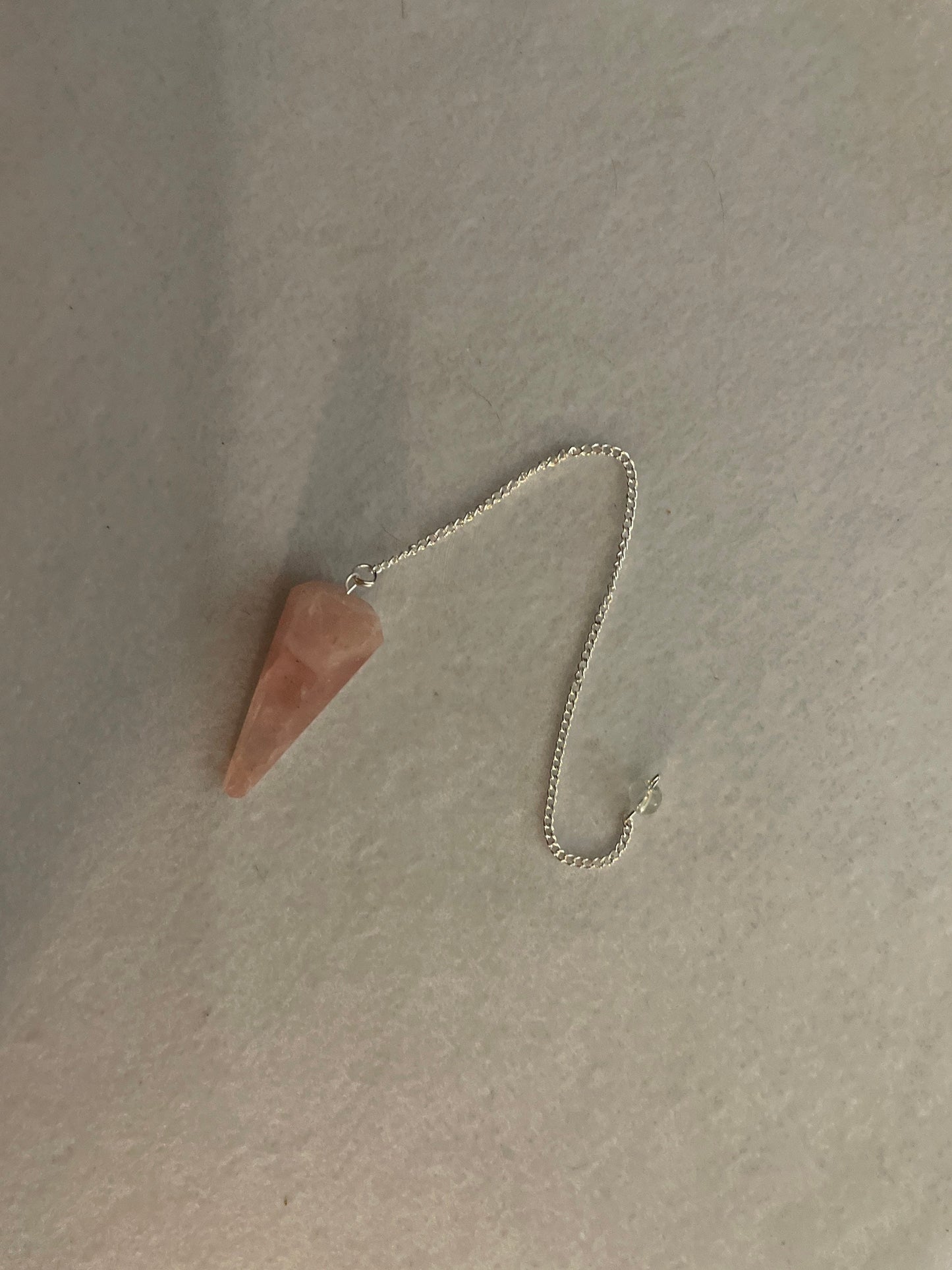 This beautiful Rose Quartz Pendulum is 1.75” and with chain is 8.25”
