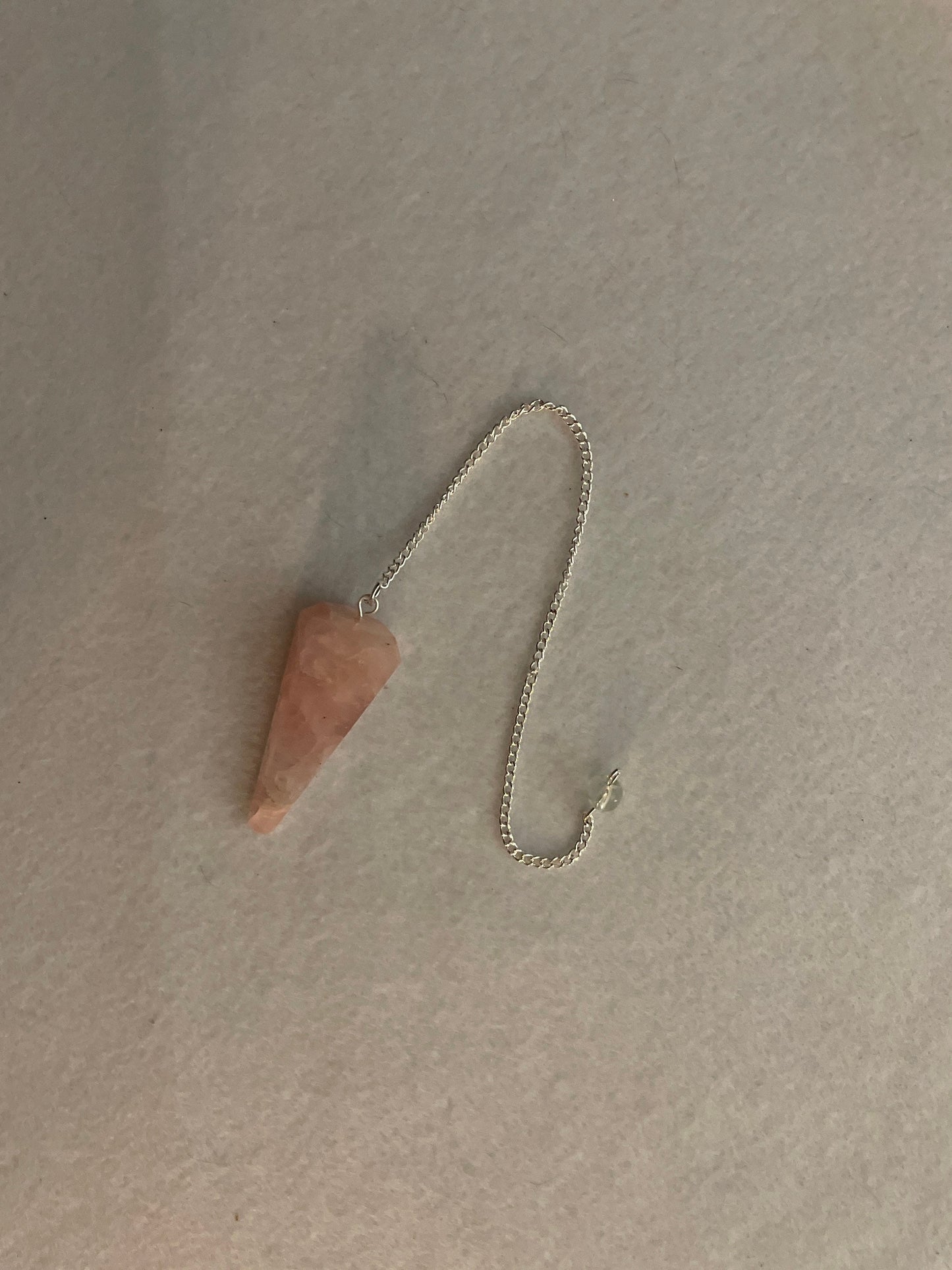 This beautiful Rose Quartz Pendulum is 1.75” and with chain is 8.25”