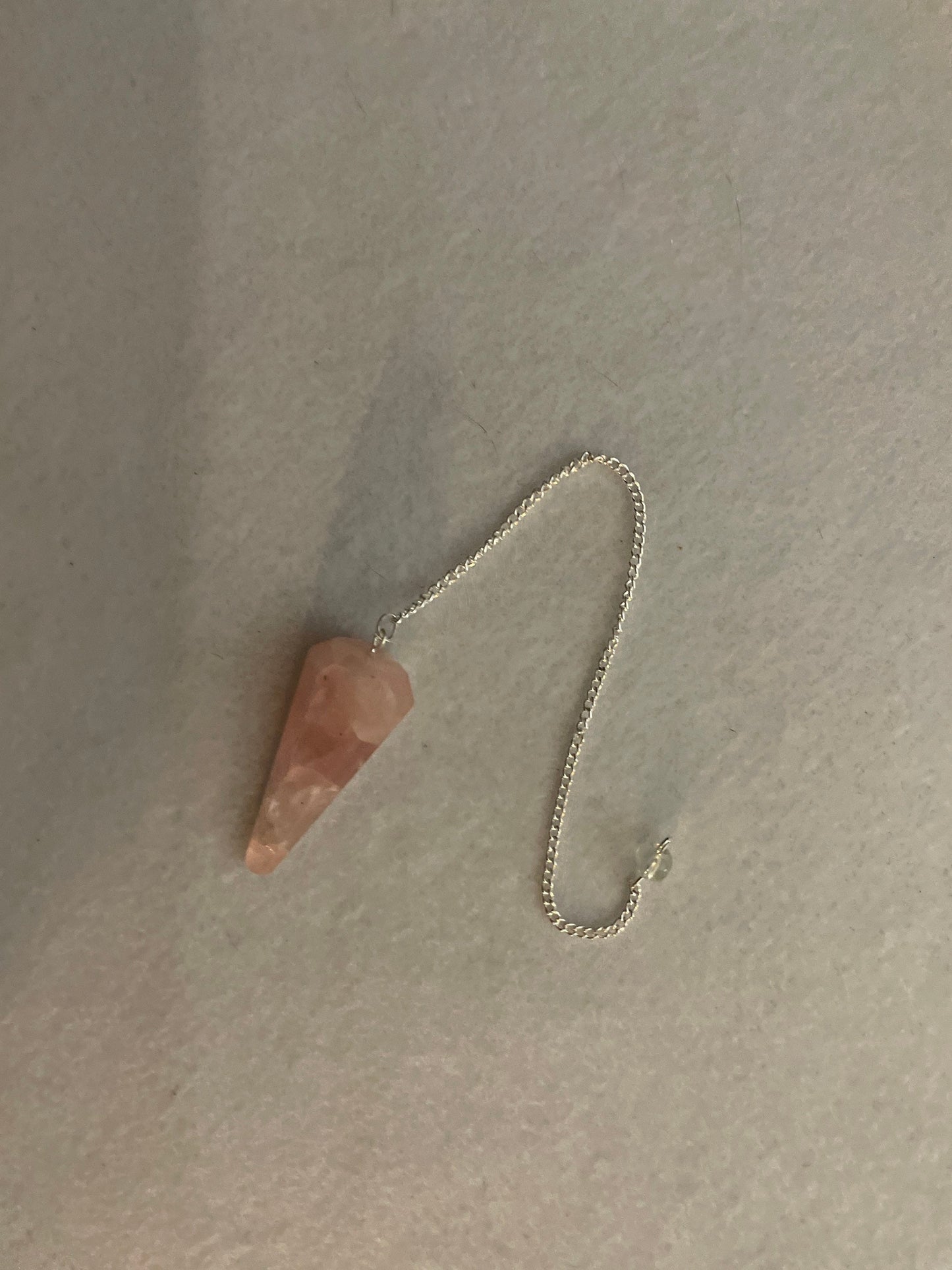 This beautiful Rose Quartz Pendulum is 1.75” and with chain is 8.25”