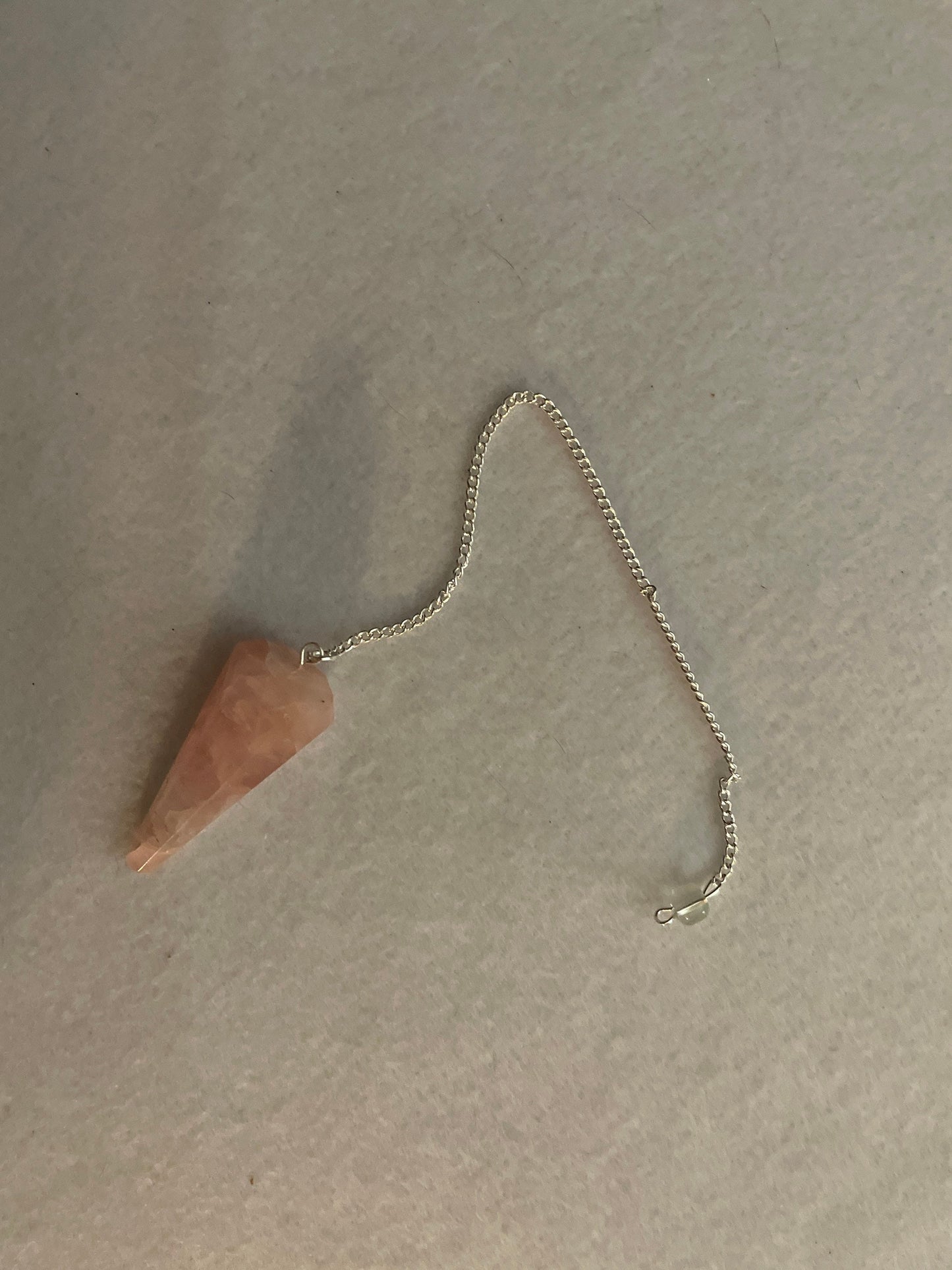 This beautiful Rose Quartz Pendulum is 1.75” and with chain is 8.25”