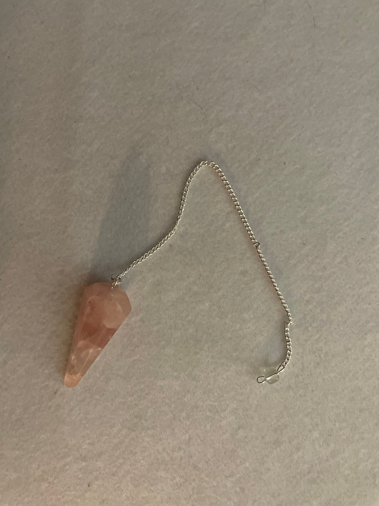 This beautiful Rose Quartz Pendulum is 1.75” and with chain is 8.25”