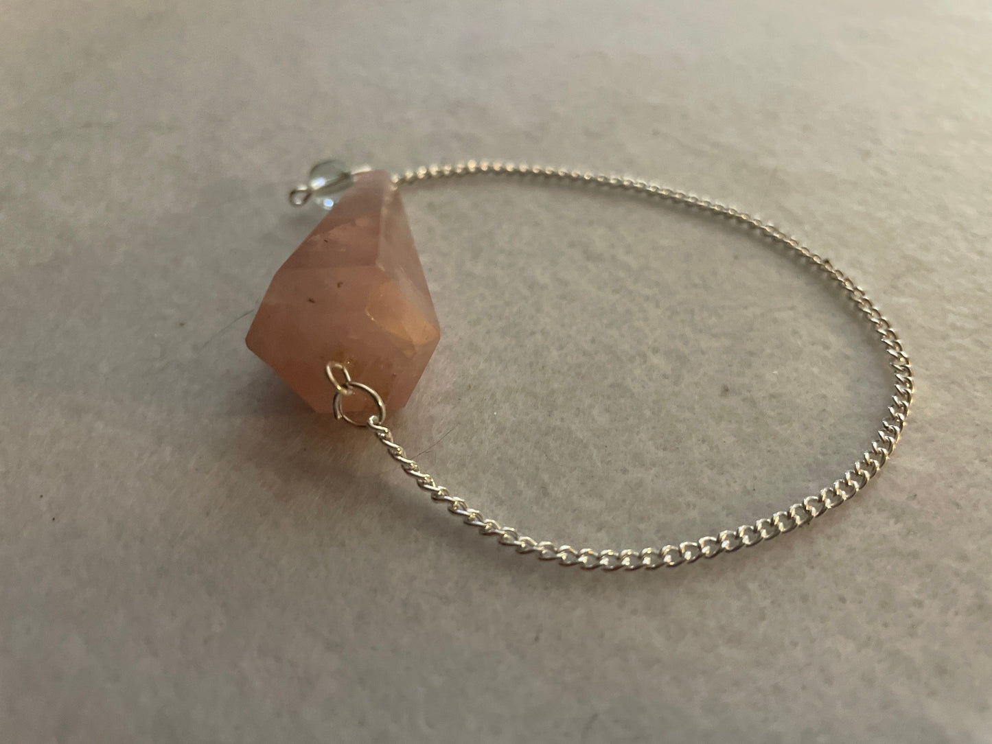 This beautiful Rose Quartz Pendulum is 1.75” and with chain is 8.25”